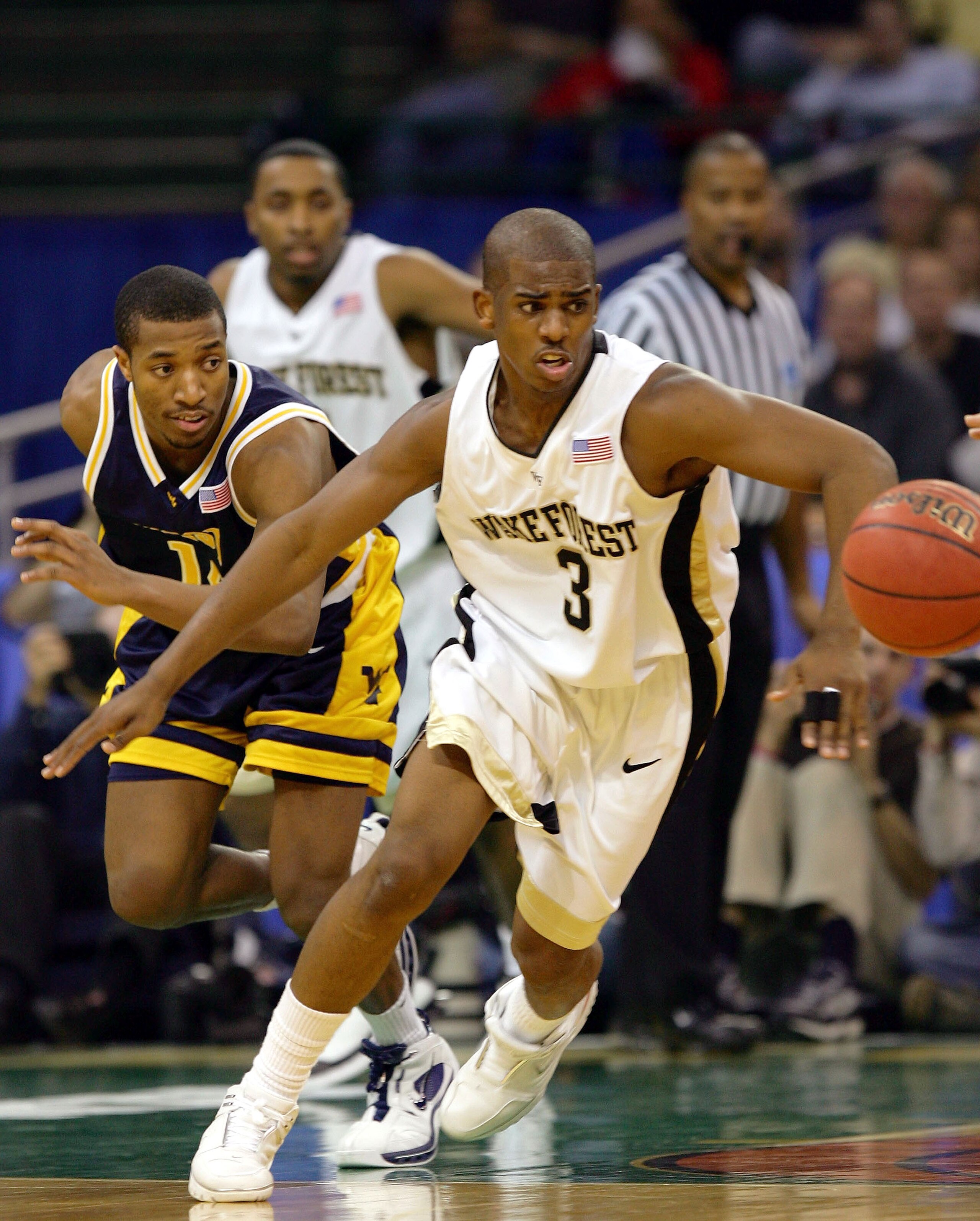 CLEVELAND - MARCH 19: Chris Paul #3 of the Wake Forest Demon Deacons chases a loose ball ahead of Darris Nichols #14 of the West Virginia Mountaineers during the second round of the 2005 NCAA Championship on March 19, 2005 at the Wolstein Center in Cleve CLEVELAND - MARCH 19: Chris Paul #3 of the Wake Forest Demon Deacons chases a loose ball ahead of Darris Nichols #14 of the West Virginia Mountaineers during the second round of the 2005 NCAA Championship on March 19, 2005 at the Wolstein Center in Cleve