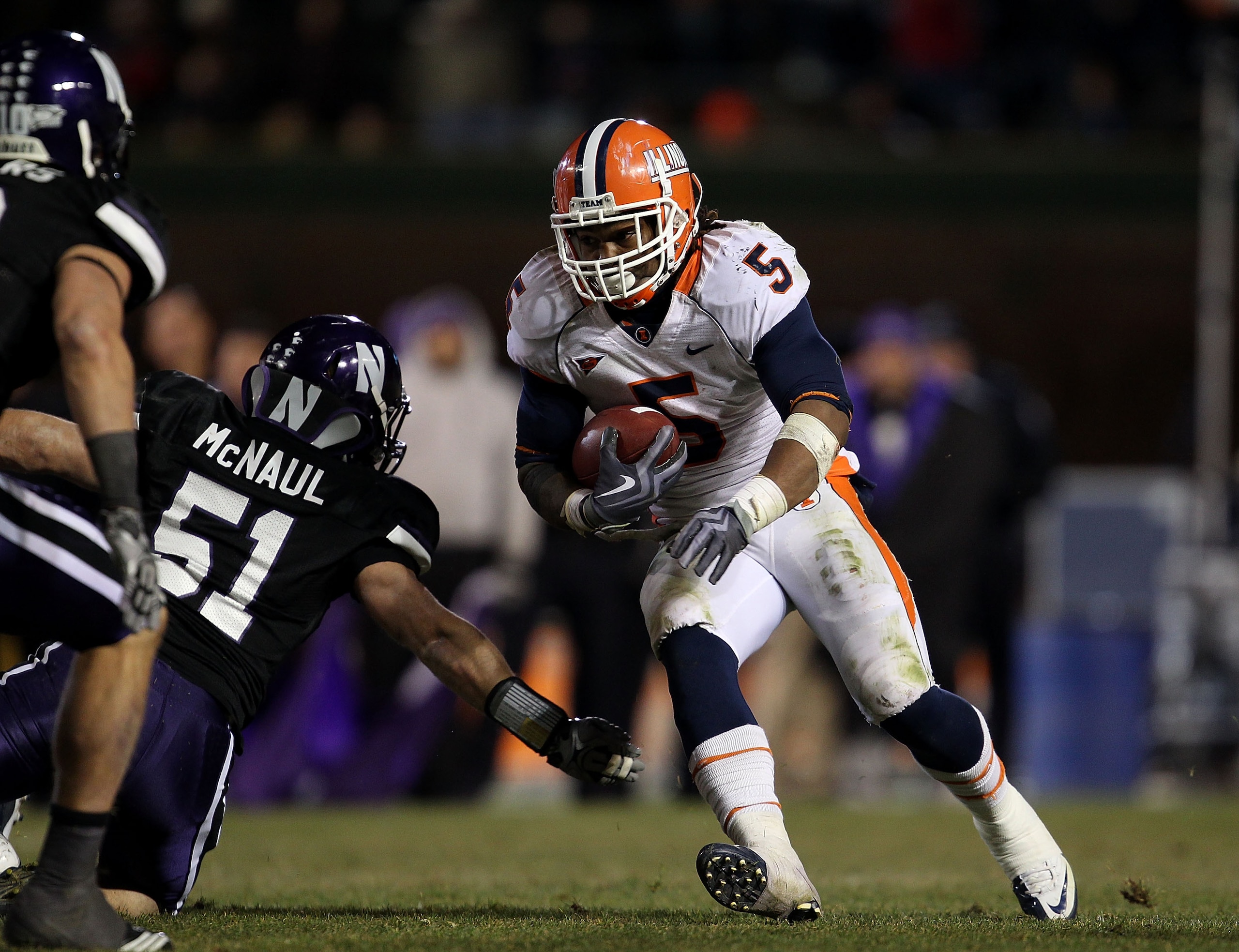 CHICAGO - NOVEMBER 20: Mikel Leshoure #5 of the Illinois Fighting Illini runs past Bryce McNaul #51 of the Northwestern Wildcats on his way to a 339 yard rushing performance during a game played at Wrigley Field on November 20, 2010 in Chicago, Illinois. 