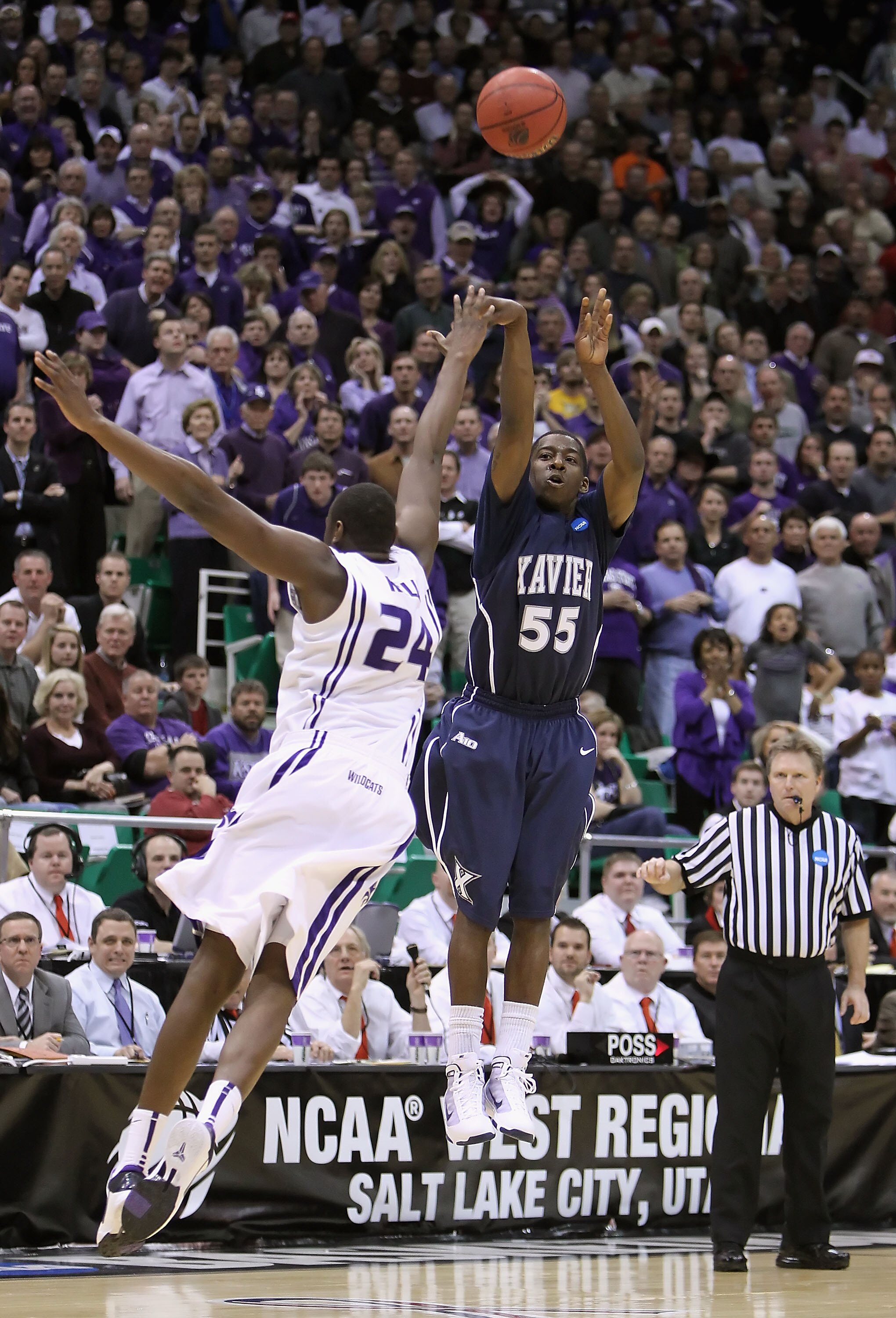 SALT LAKE CITY - MARCH 25:  Jordan Crawford #55 of the Xavier Musketeers hits a three point shot over Curtis Kelly #24 of the Kansas State Wildcats to force double overtime during the west regional semifinal of the 2010 NCAA men's basketball tournament at