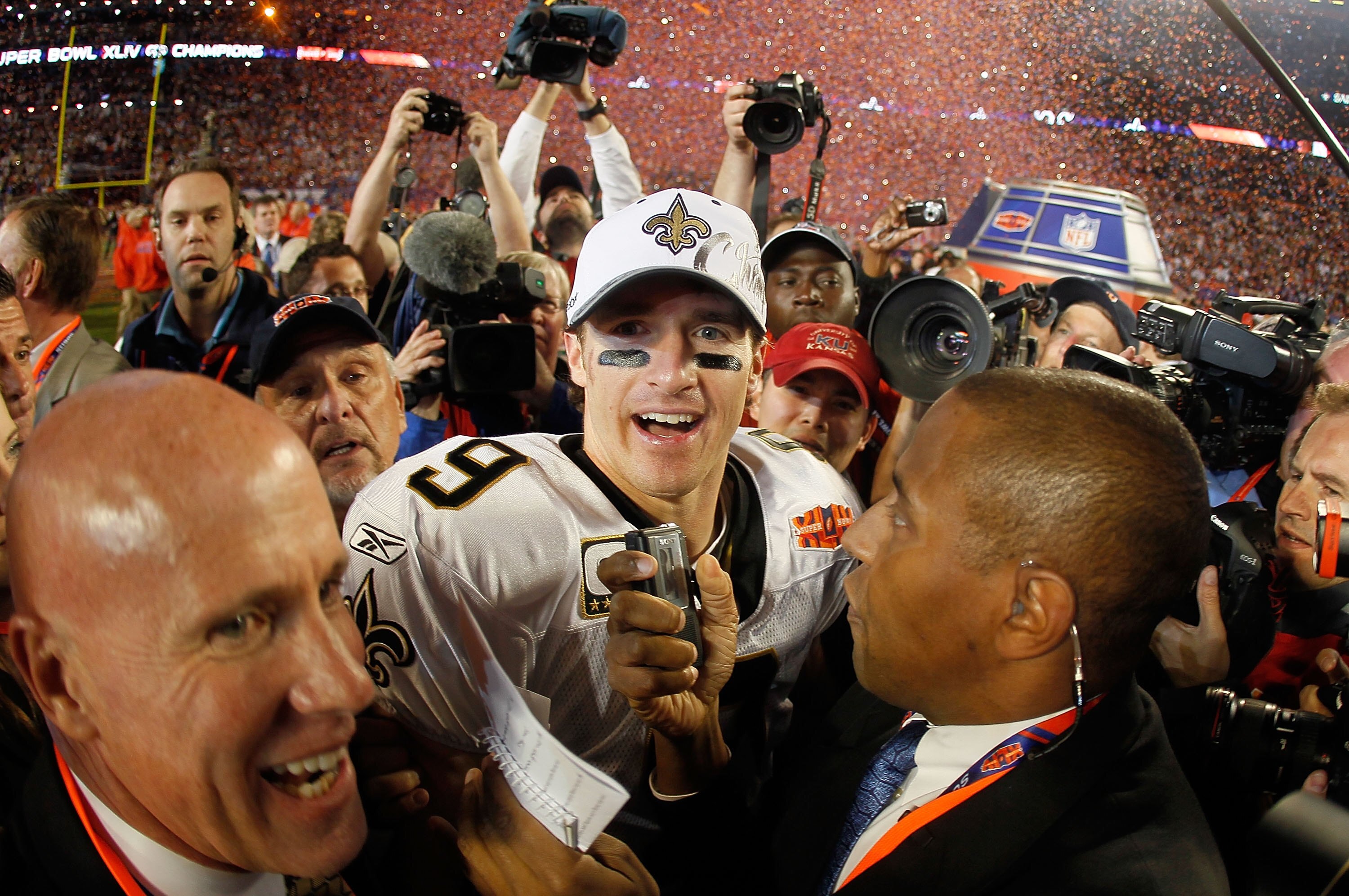 MIAMI GARDENS, FL - FEBRUARY 07:  Drew Brees #9 of the New Orleans Saints is interviewed on the field after his team defeated the Indianapolis Colts during Super Bowl XLIV on February 7, 2010 at Sun Life Stadium in Miami Gardens, Florida.  (Photo by Donal