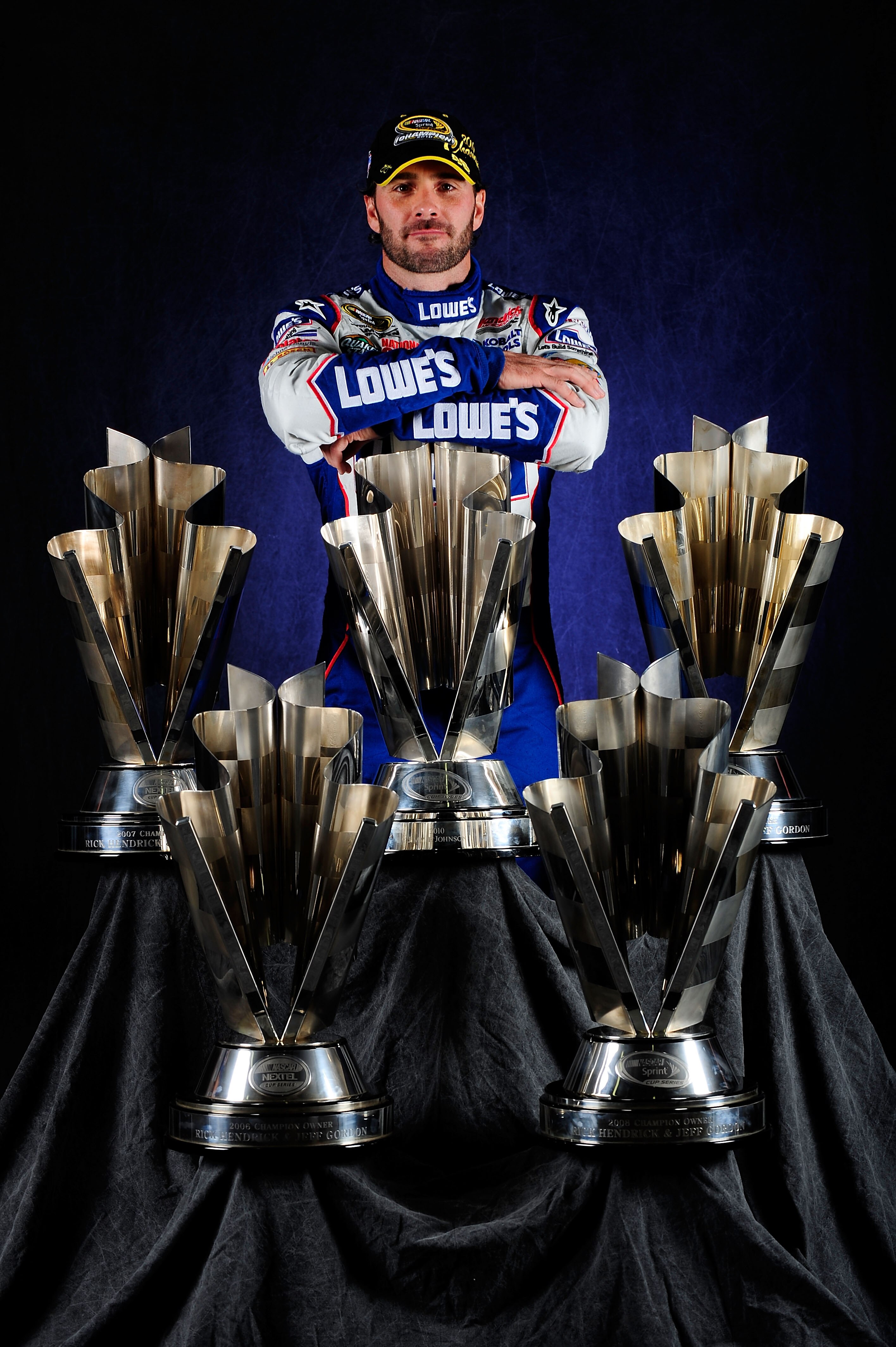 HOMESTEAD, FL - NOVEMBER 21:  NASCAR Champion Jimmie Johnson, driver of the #48 Lowe's Chevrolet, poses with the Sprint Cup Series Championship trophies at Homestead-Miami Speedway on November 21, 2010 in Homestead, Florida. Johnson clinched his fifth str