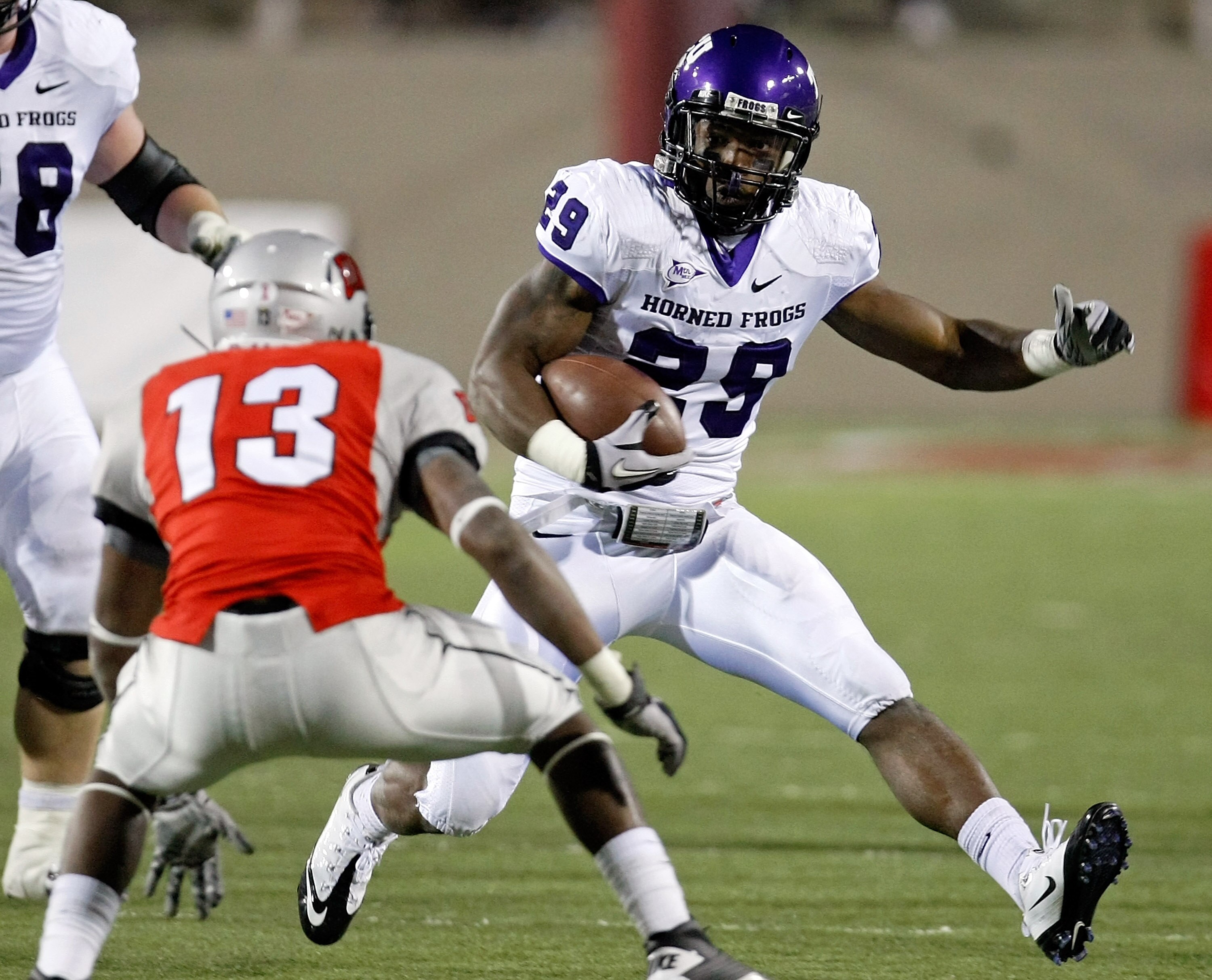 LAS VEGAS - OCTOBER 30:  Matthew Tucker #29 of the Texas Christian University Horned Frogs runs for yardage against Eric Tuiloma #13 of the UNLV Rebels at Sam Boyd Stadium October 30, 2010 in Las Vegas, Nevada. TCU won 48-6.  (Photo by Ethan Miller/Getty