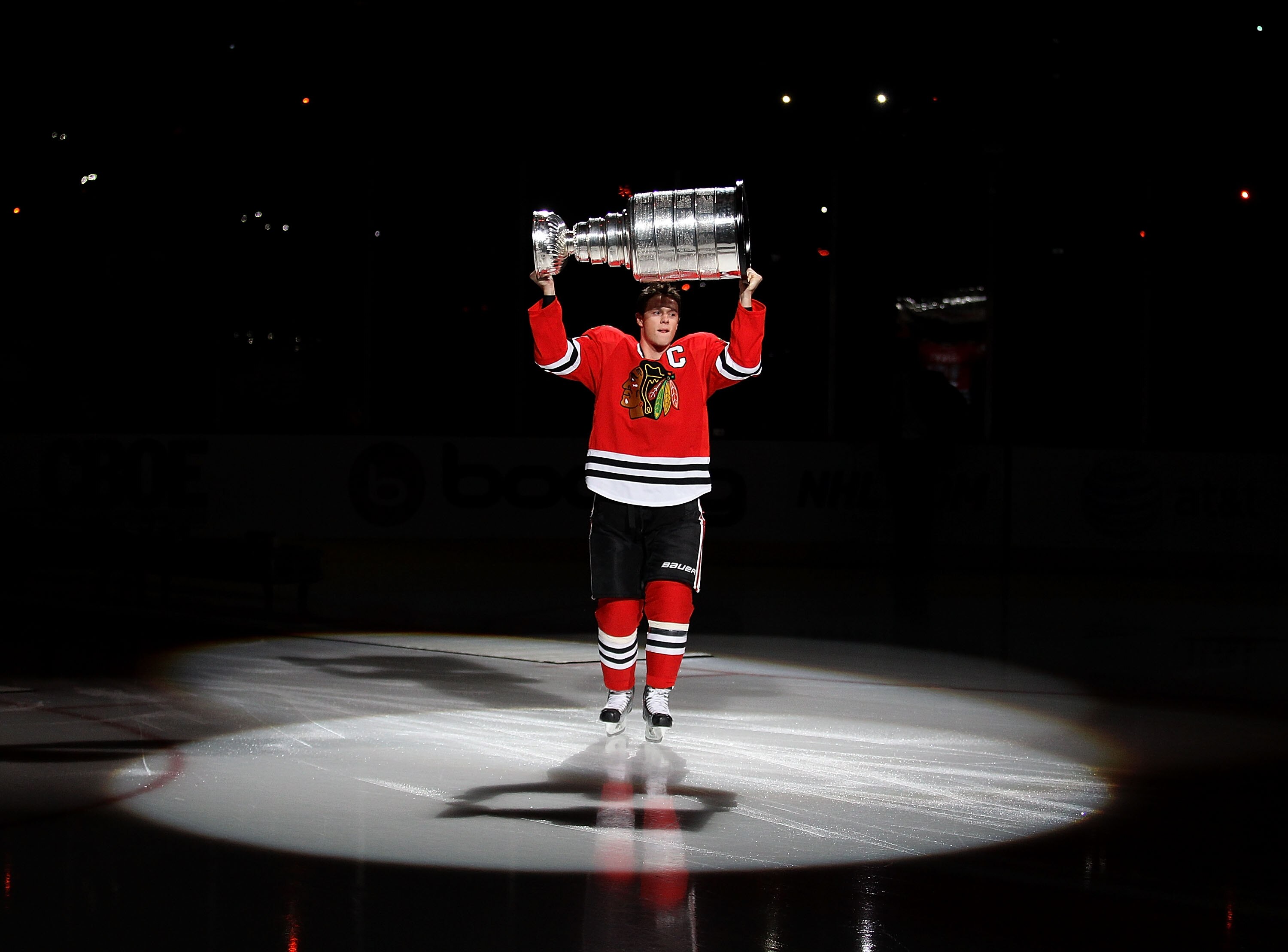 CHICAGO - OCTOBER 09: Jonathan Toews #19 of the Chicago Blackhawks carries the Stanley Cup across the ice in a ceremony before the Blackhawks season home opening game against the Detroit Red Wings at the United Center on October 9, 2010 in Chicago, Illino