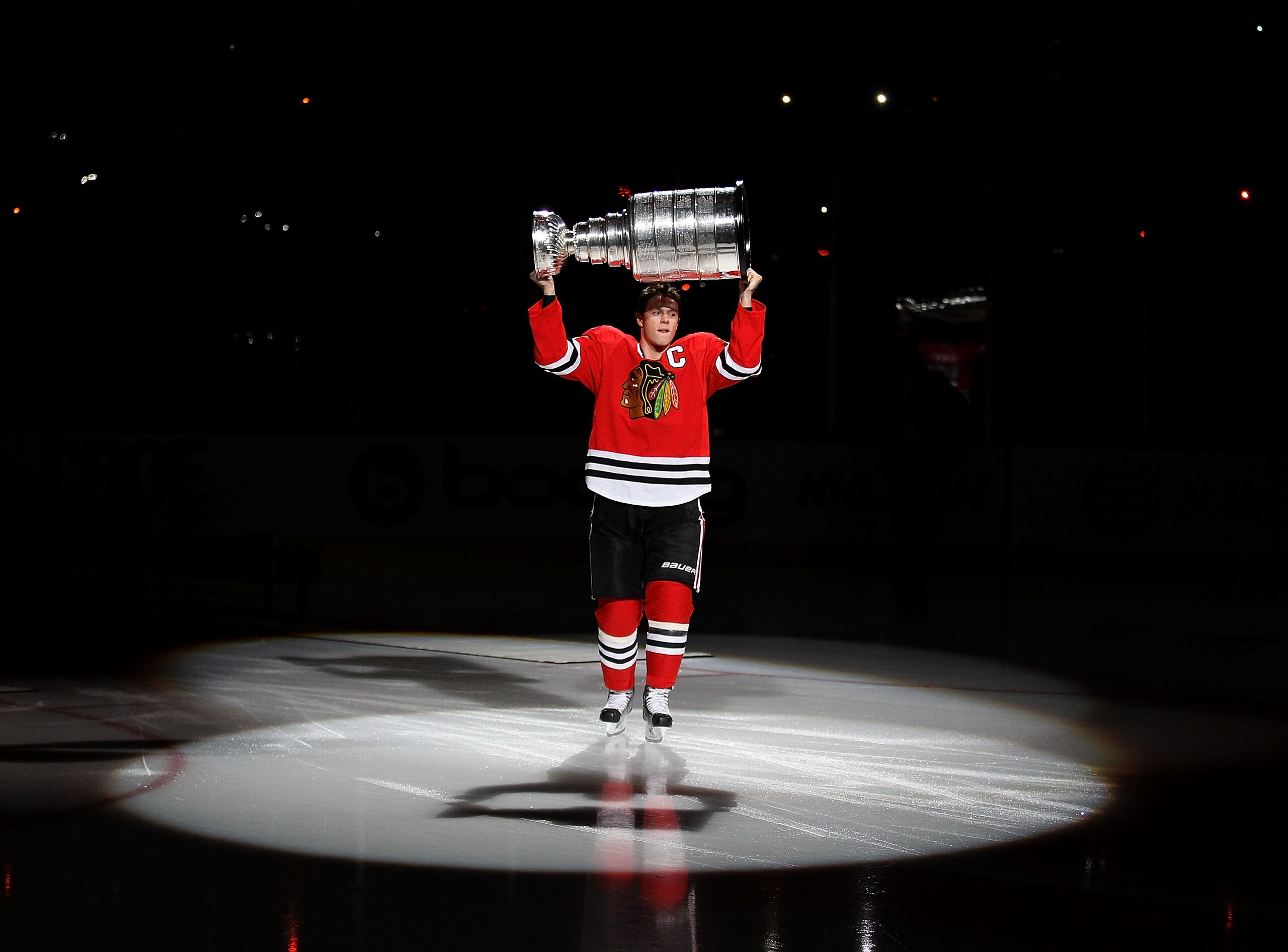 CHICAGO - OCTOBER 09: Jonathan Toews #19 of the Chicago Blackhawks carries the Stanley Cup across the ice in a ceremony before the Blackhawks season home opening game against the Detroit Red Wings at the United Center on October 9, 2010 in Chicago, Illino