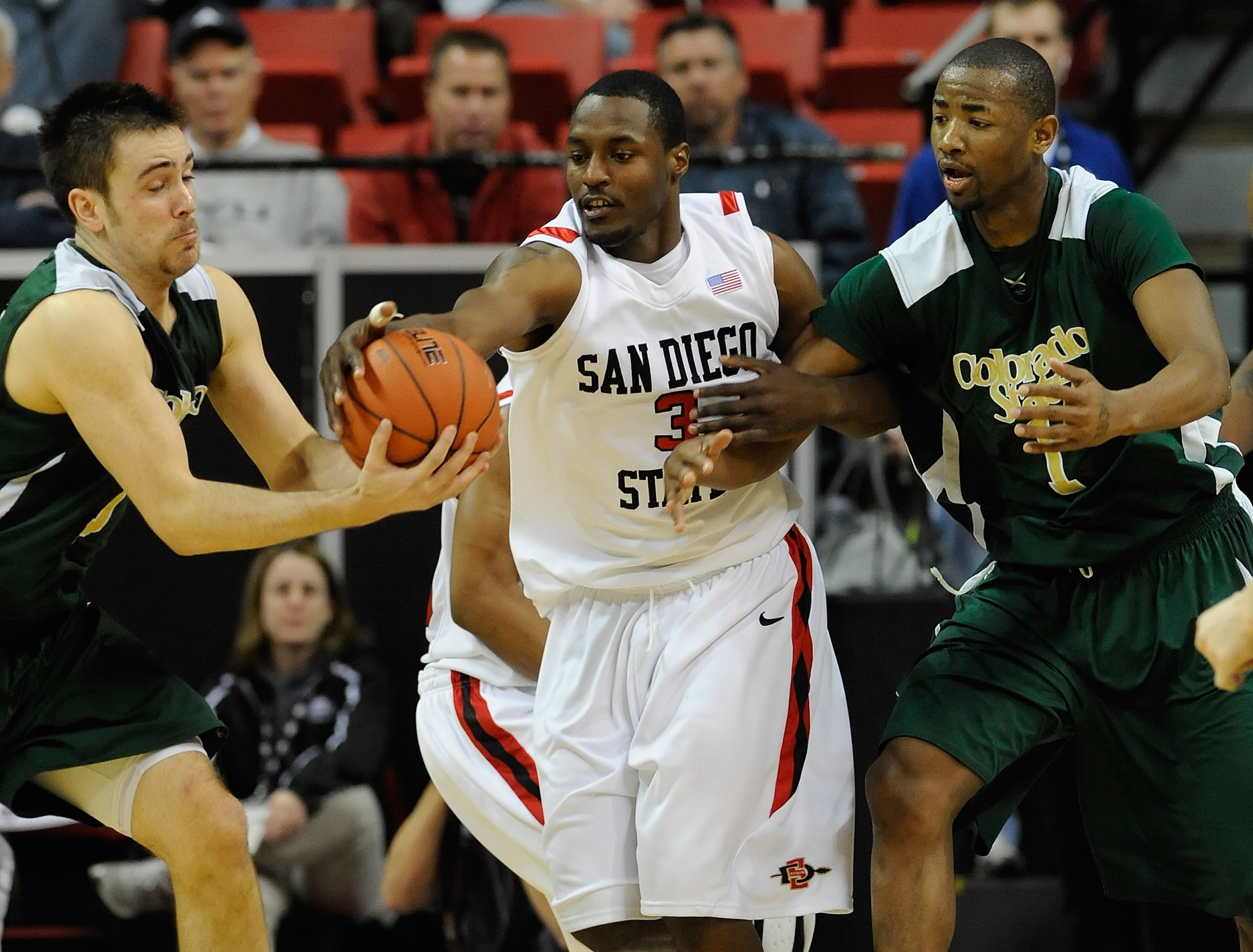 LAS VEGAS - MARCH 11:  Tyrone Shelley #3 of the San Diego State Aztecs fights Travis Busch #10 and Travis Franklin #1 of the Colorado State Rams for a loose ball during a quarterfinal game of the Conoco Mountain West Conference Basketball tournament at th