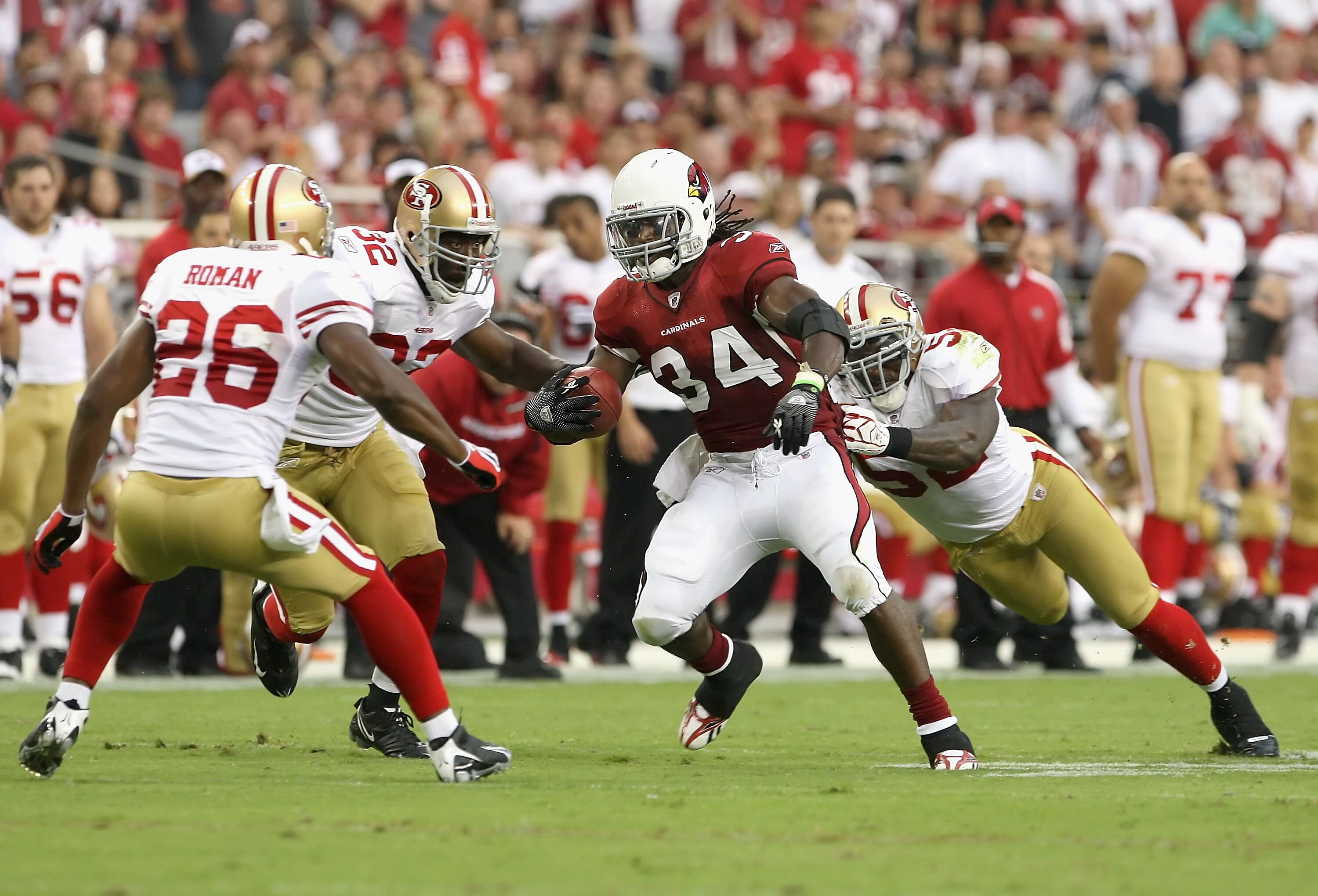 GLENDALE, AZ - SEPTEMBER 13:  Runningback Tim Hightower #34 of the Arizona Cardinals rushes the football against Mark Roman #26, Michael Lewis #32 and Patrick Willis #52 of the San Francisco 49ers during the NFL game at the Universtity of Phoenix Stadium