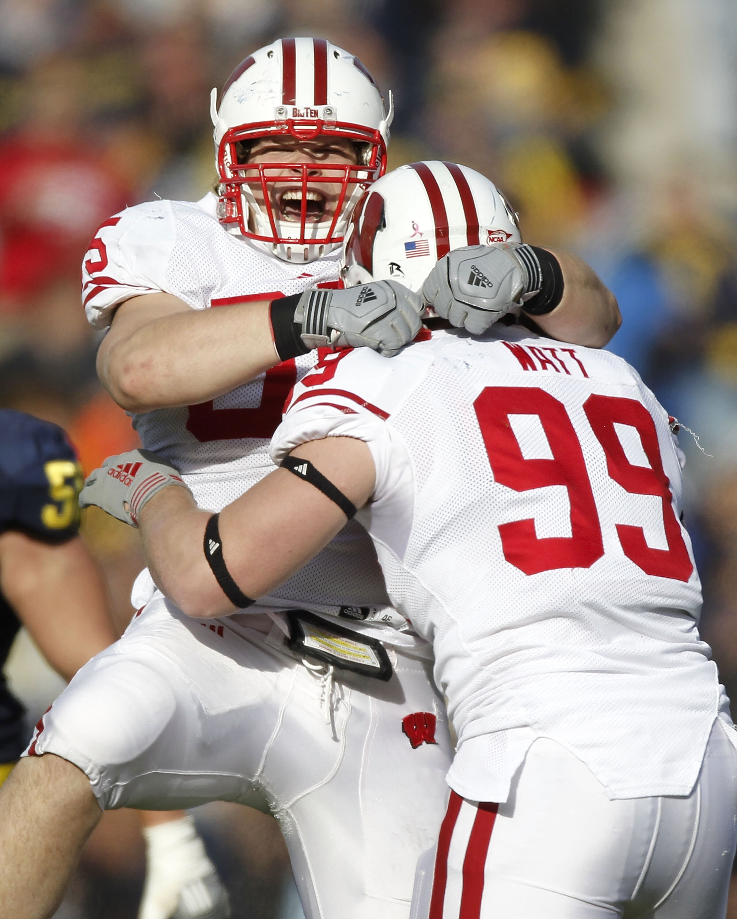 ANN ARBOR, MI - NOVEMBER 20:  J.J. Watt #99 of the Wisconsin Badgers celebrates a fourth quarter interception with Patrick Butrym #95 while playing the Michigan Wolverines at Michigan Stadium on November 20, 2010 in Ann Arbor, Michigan. Wisconson won the