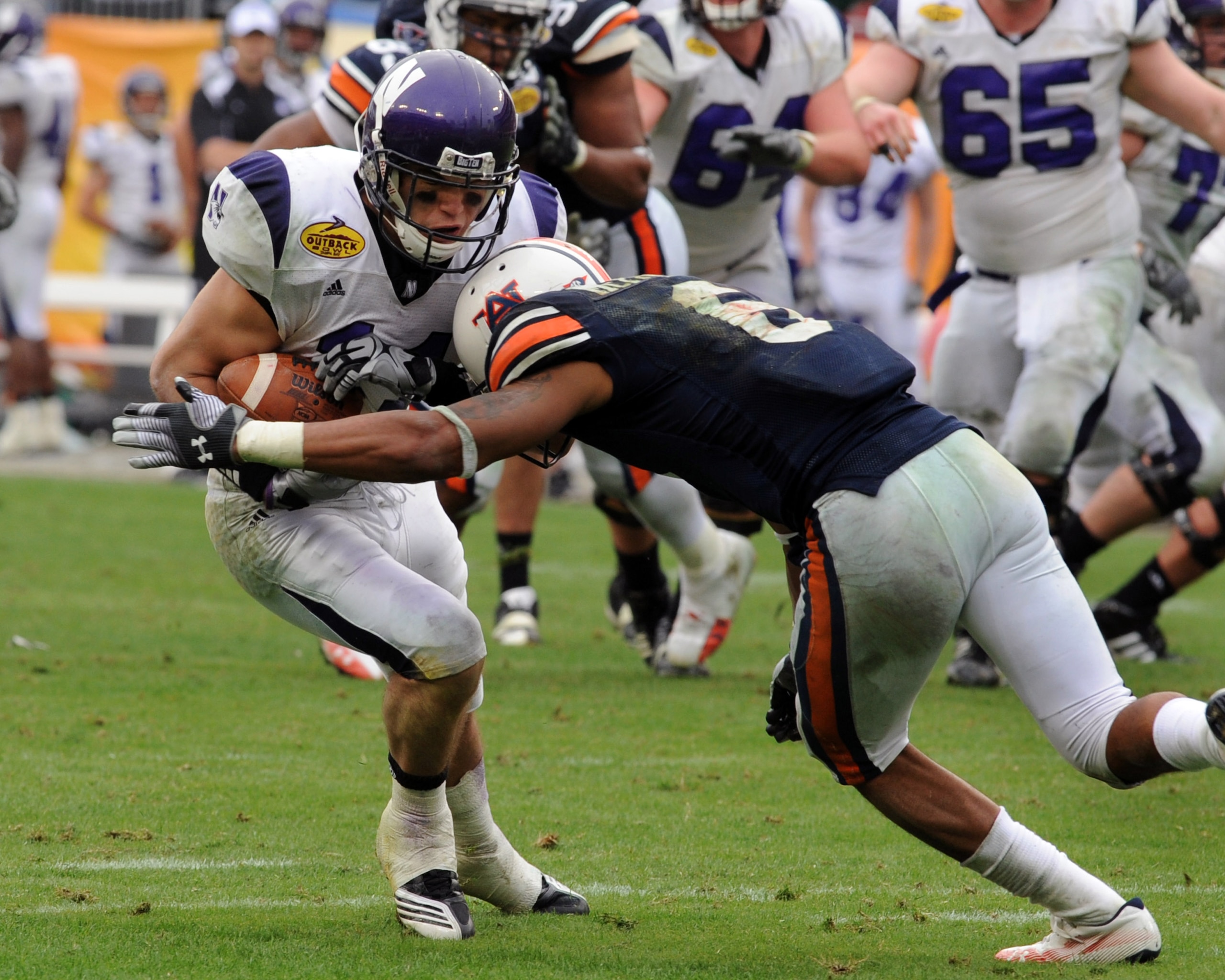 TAMPA, FL - JANUARY 1: Wide receiver Jeremy Ebert #11 of the Northwestern Wildcats grabs a pass against the Auburn Tigers in the Outback Bowl January 1, 2010 at Raymond James Stadium in Tampa, Florida.  (Photo by Al Messerschmidt/Getty Images)