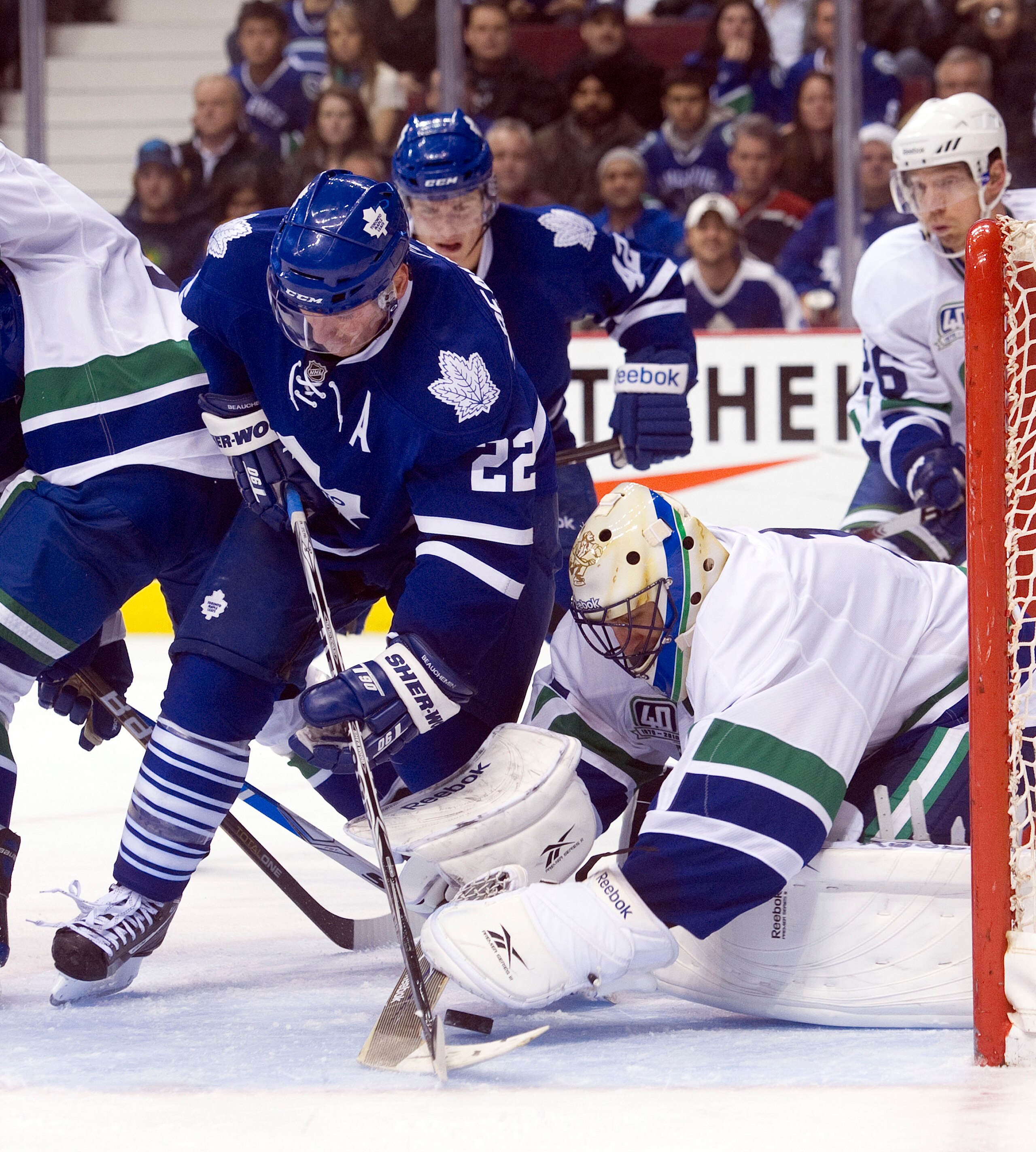 VANCOUVER, CANADA - DECEMBER 18: Goalie Roberto Luongo #1 of the Vancouver Canucks covers up the puck before Francois Beauchemin #22 of the Toronto Maple Leafs can get his stick on the loose puck during the third period in NHL action on December 18, 2010