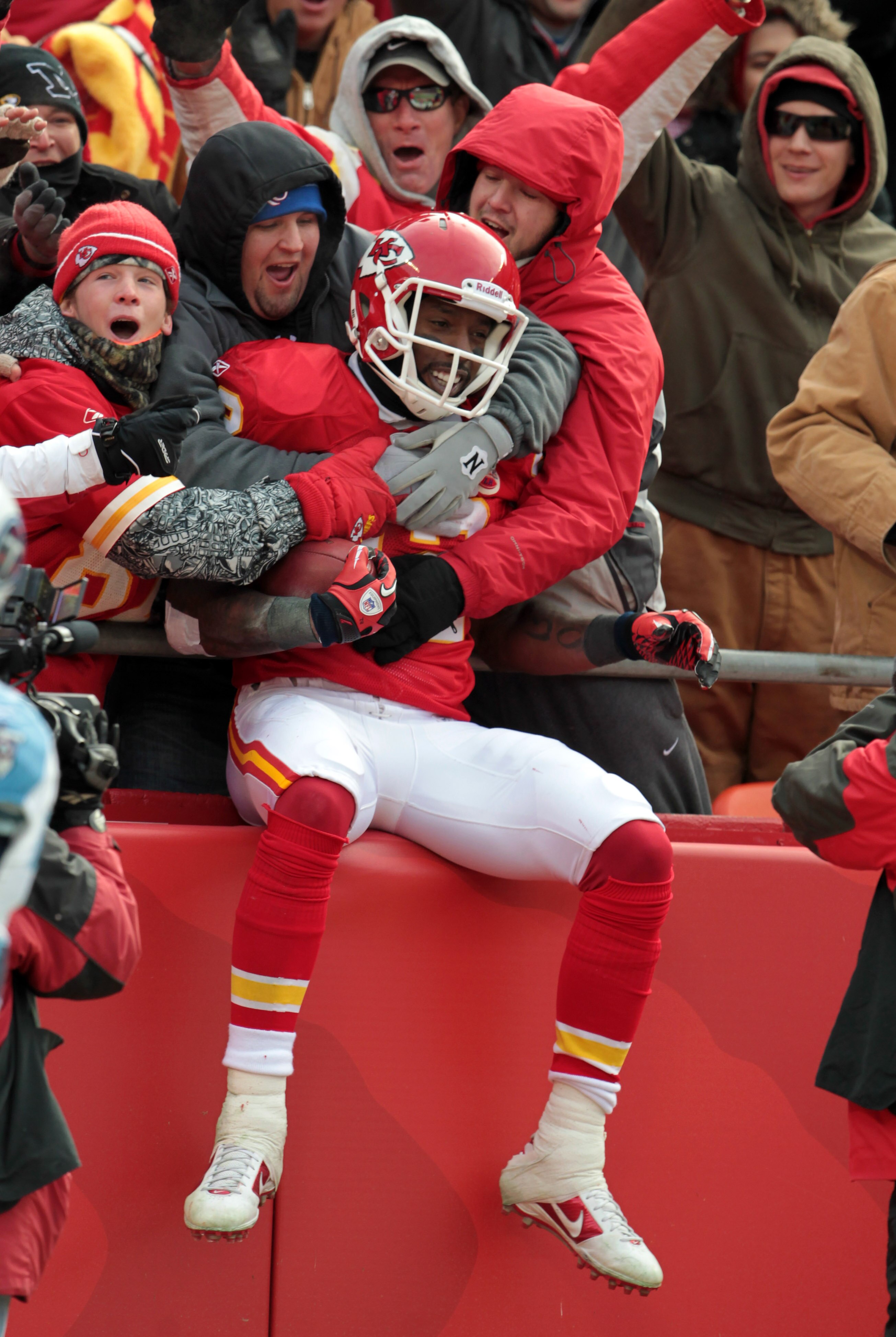 KANSAS CITY, MO - DECEMBER 26:  Receiver Dwayne Bowe #82 of the Kansas City Chiefs is congratulated by fans as he jumps into the stands after making a 75 yard touchdown catch during the game against the Tennessee Titans on December 26, 2010 at Arrowhead S