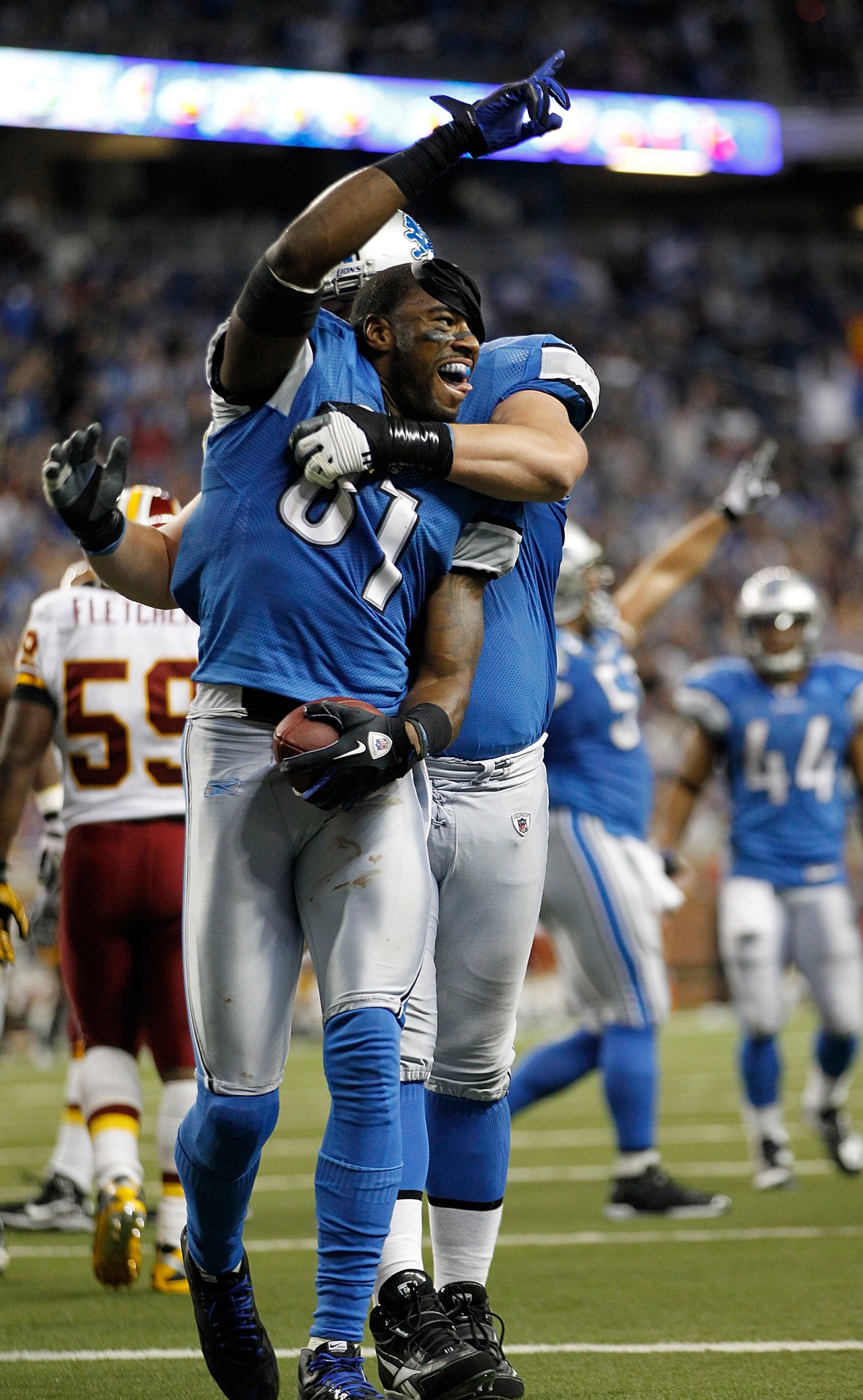 DETROIT - OCTOBER 31: Calvin Johnson #81 of the Detroit Lions celebrates with teammate Jeff Backus #76 after scoring a touchdown during the fourth quarter of the game against the Washington Redskins at Ford Field on October 31, 2010 in Detroit, Michigan.