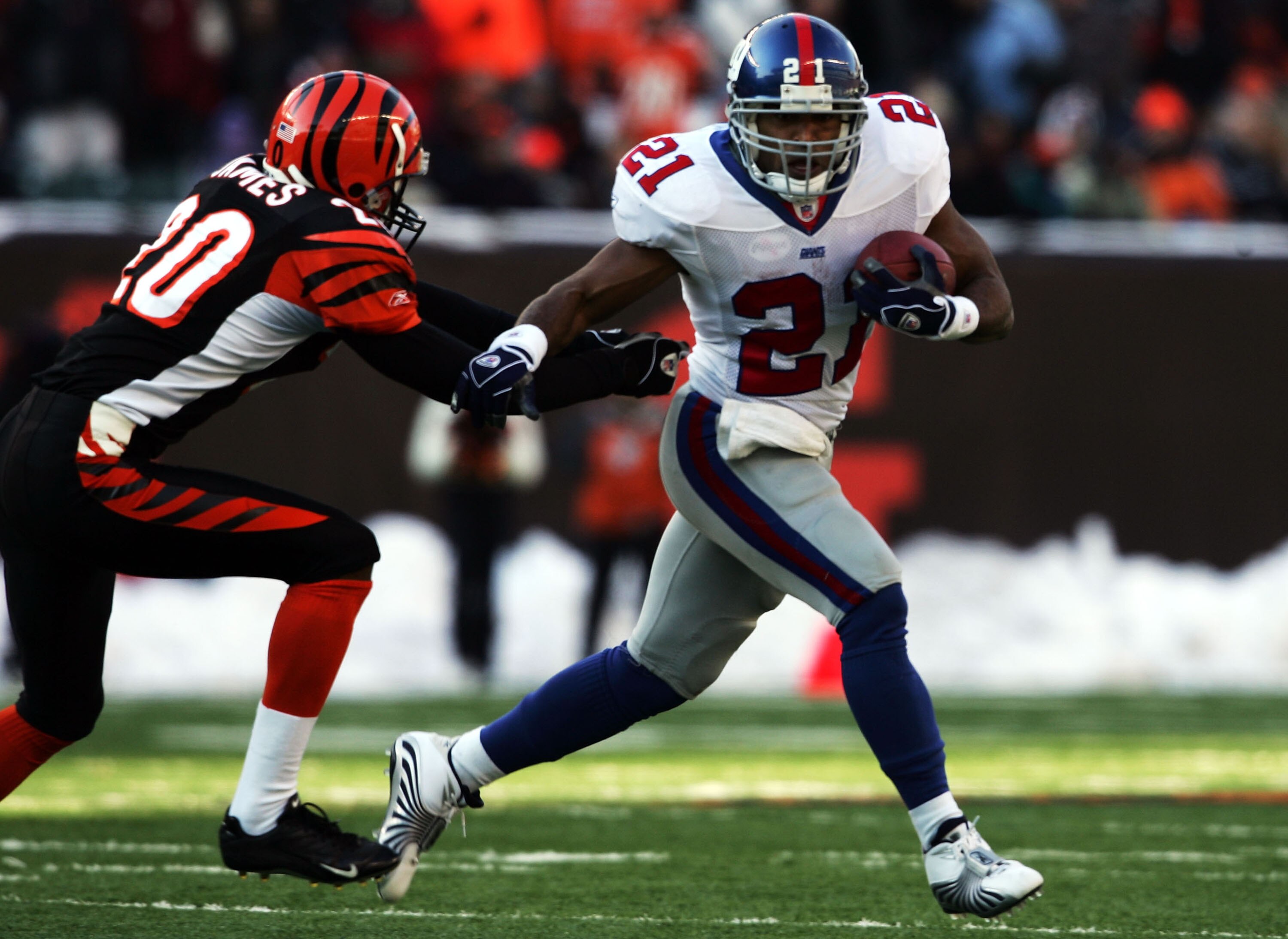 CINCINNATI - DECEMBER 26:  Tory James #20 of the Cincinnati Bengals chases Tiki Barber #21 of the New York Giants during the NFL game on December 26, 2004 at Paul Brown Stadium in Cincinnati, Ohio. The Bengsals won 23-22.  (Photo by Andy Lyons/Getty Image