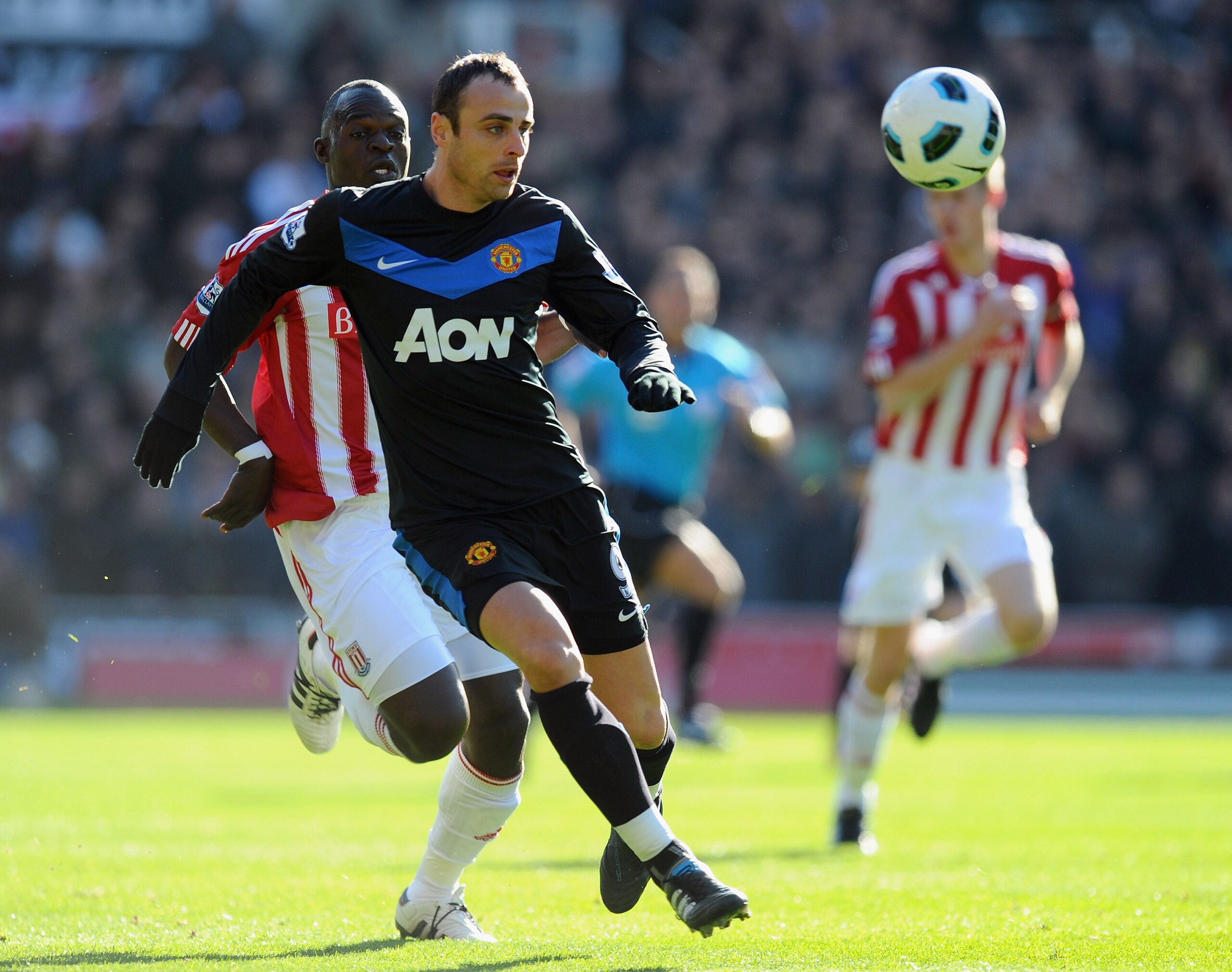 STOKE ON TRENT, ENGLAND - OCTOBER 24:  Dimitar Berbatov of Manchester United gets away from Abdoulaye Faye of Stoke during the Barclays Premier League match between Stoke City and Manchester United at Britannia Stadium on October 24, 2010 in Stoke on Tren