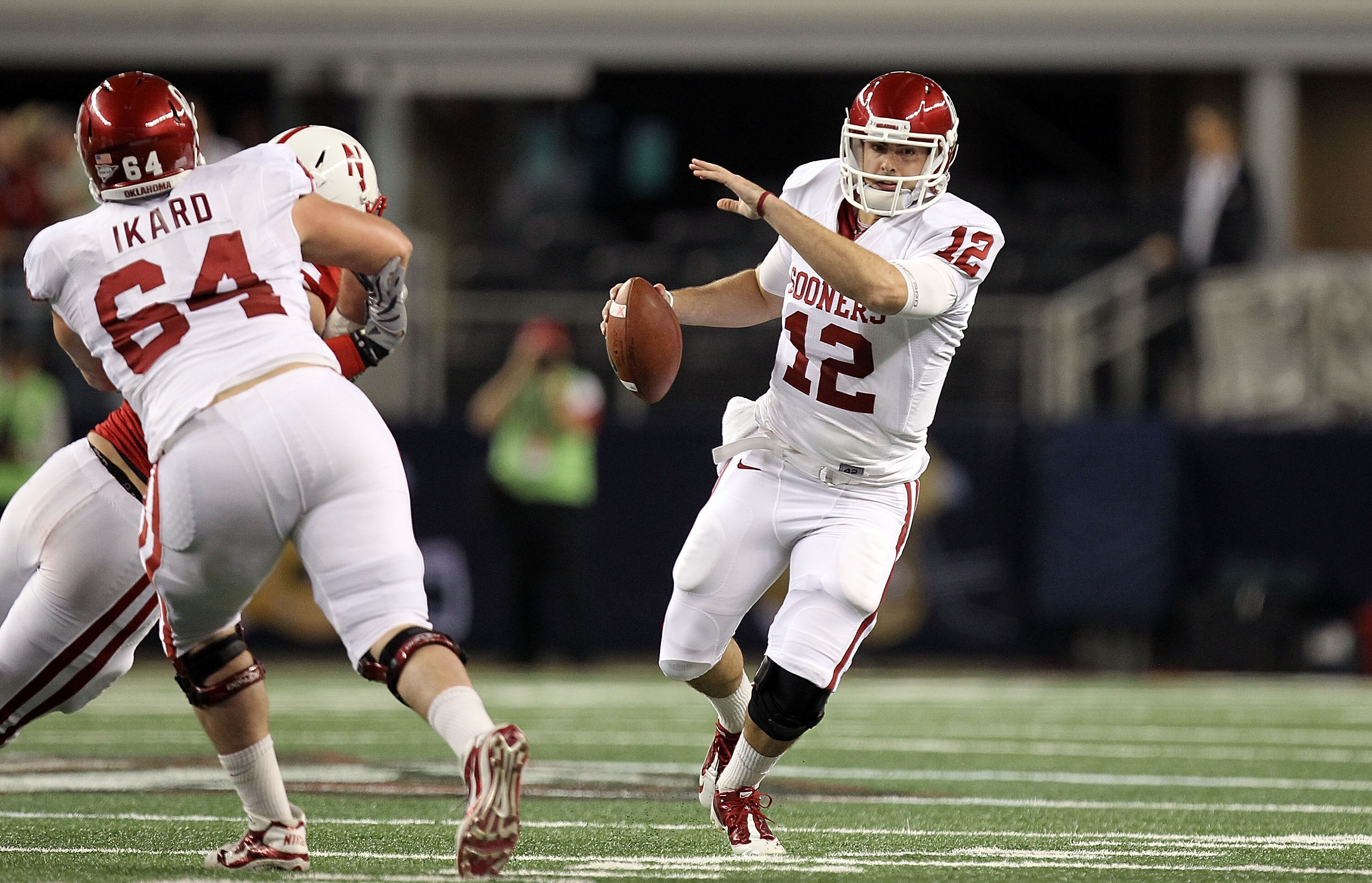 ARLINGTON, TX - DECEMBER 04:  Quarterback Landry Jones #12 of the Oklahoma Sooners drops back to pass against the Nebraska Cornhuskers during the Big 12 Championship at Cowboys Stadium on December 4, 2010 in Arlington, Texas.  (Photo by Ronald Martinez/Ge