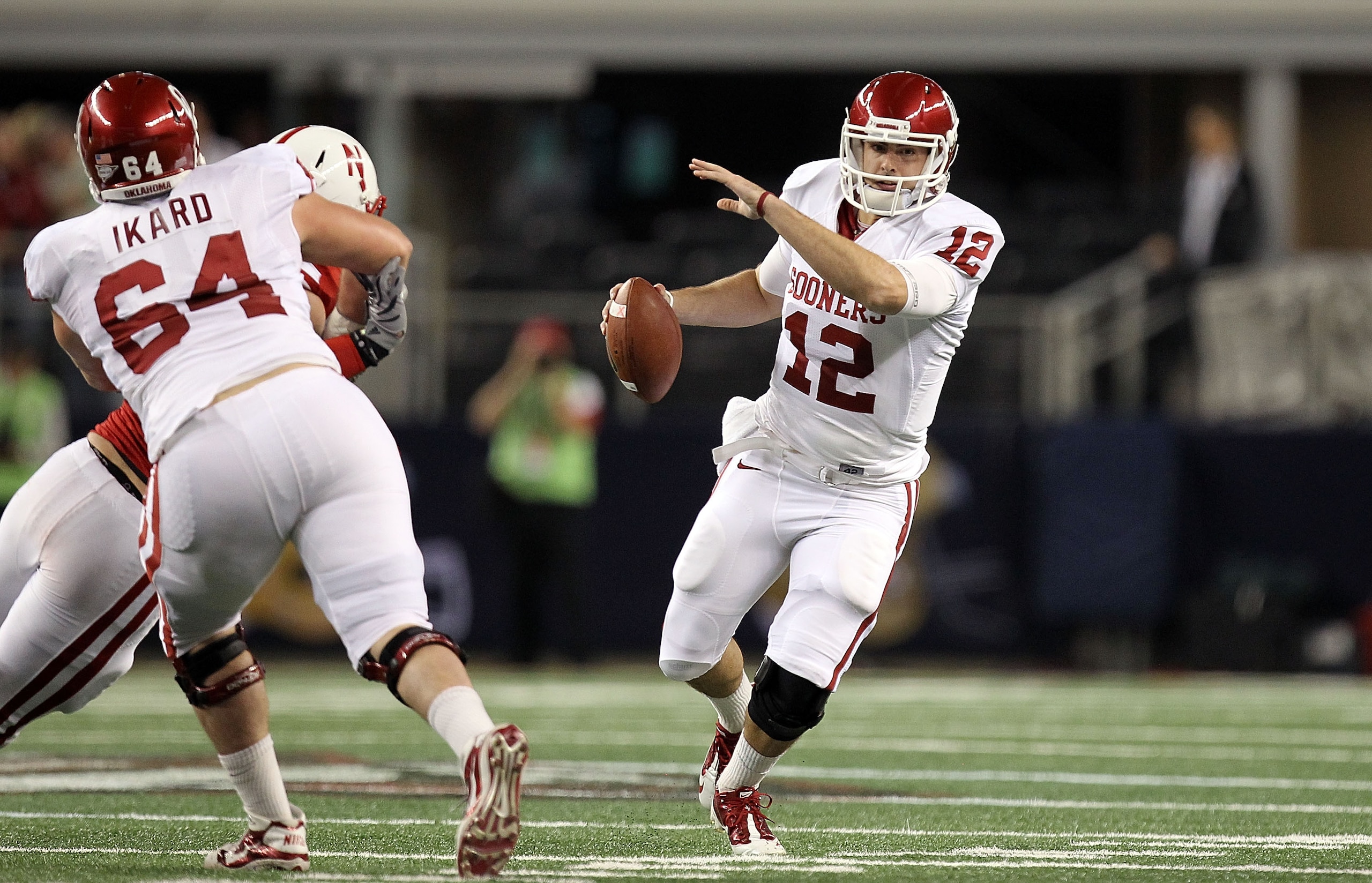 ARLINGTON, TX - DECEMBER 04:  Quarterback Landry Jones #12 of the Oklahoma Sooners drops back to pass against the Nebraska Cornhuskers during the Big 12 Championship at Cowboys Stadium on December 4, 2010 in Arlington, Texas.  (Photo by Ronald Martinez/Ge