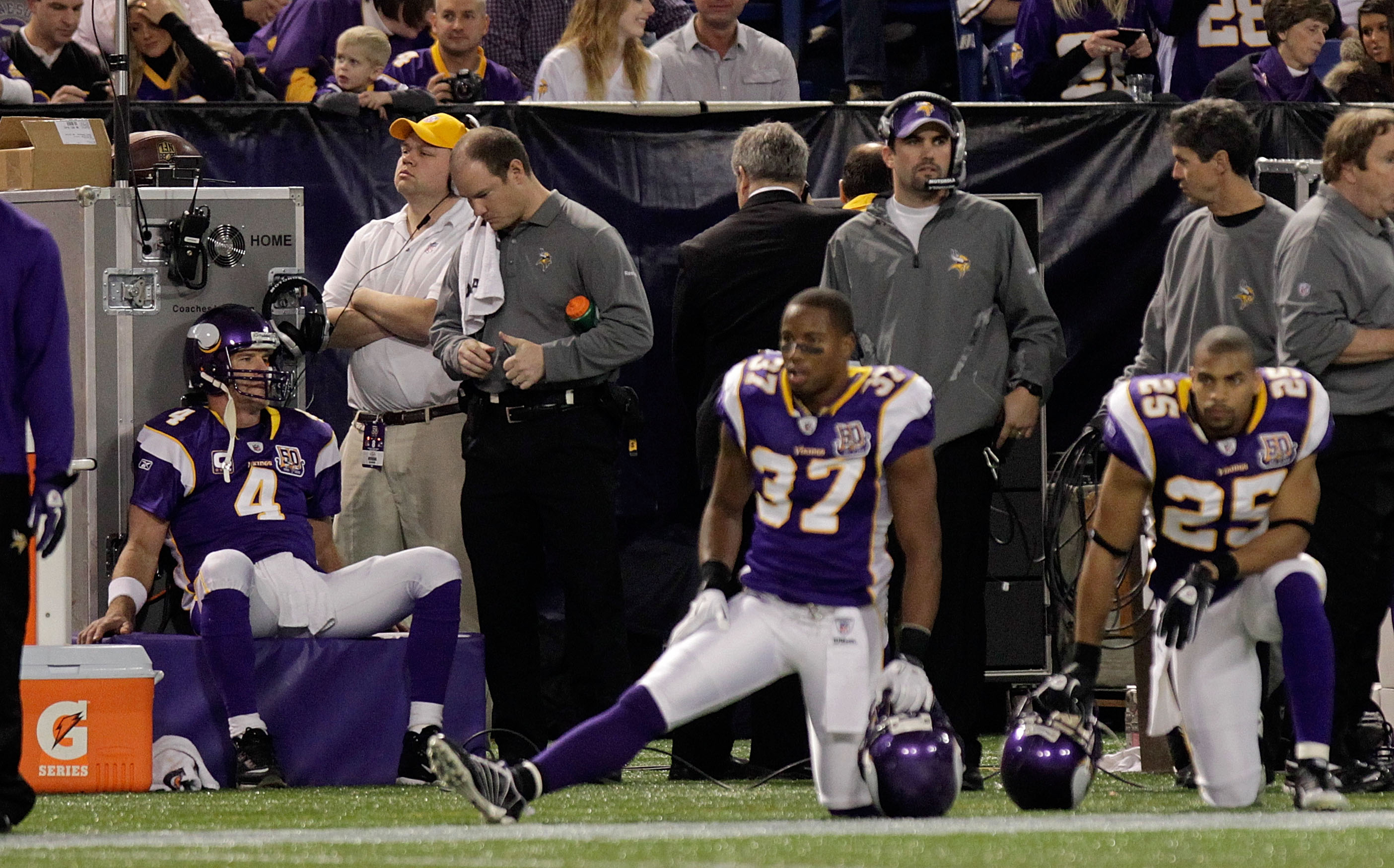 MINNEAPOLIS, MN - DECEMBER 05:  Brett Favre #4 (left) of the Minnesota Vikings sits on the sideline  against the Buffalo Bills defense at the Mall of America Field at the Hubert H. Humphrey Metrodome on December 5, 2010 in Minneapolis, Minnesota.  (Photo