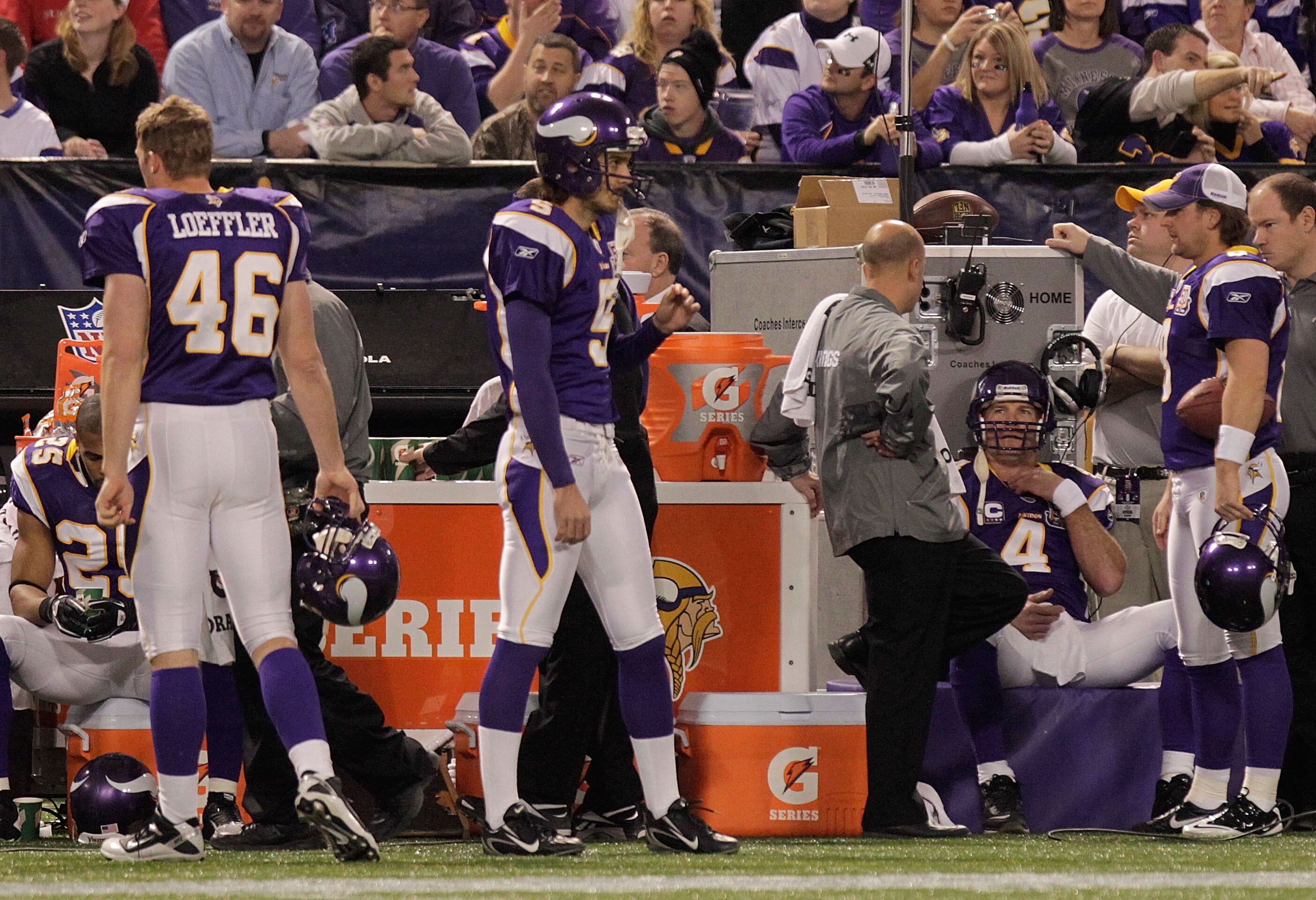 MINNEAPOLIS, MN - DECEMBER 05:  Brett Favre #4 (right) of the Minnesota Vikings sits on the sideline  against the Buffalo Bills defense at the Mall of America Field at the Hubert H. Humphrey Metrodome on December 5, 2010 in Minneapolis, Minnesota.  (Photo