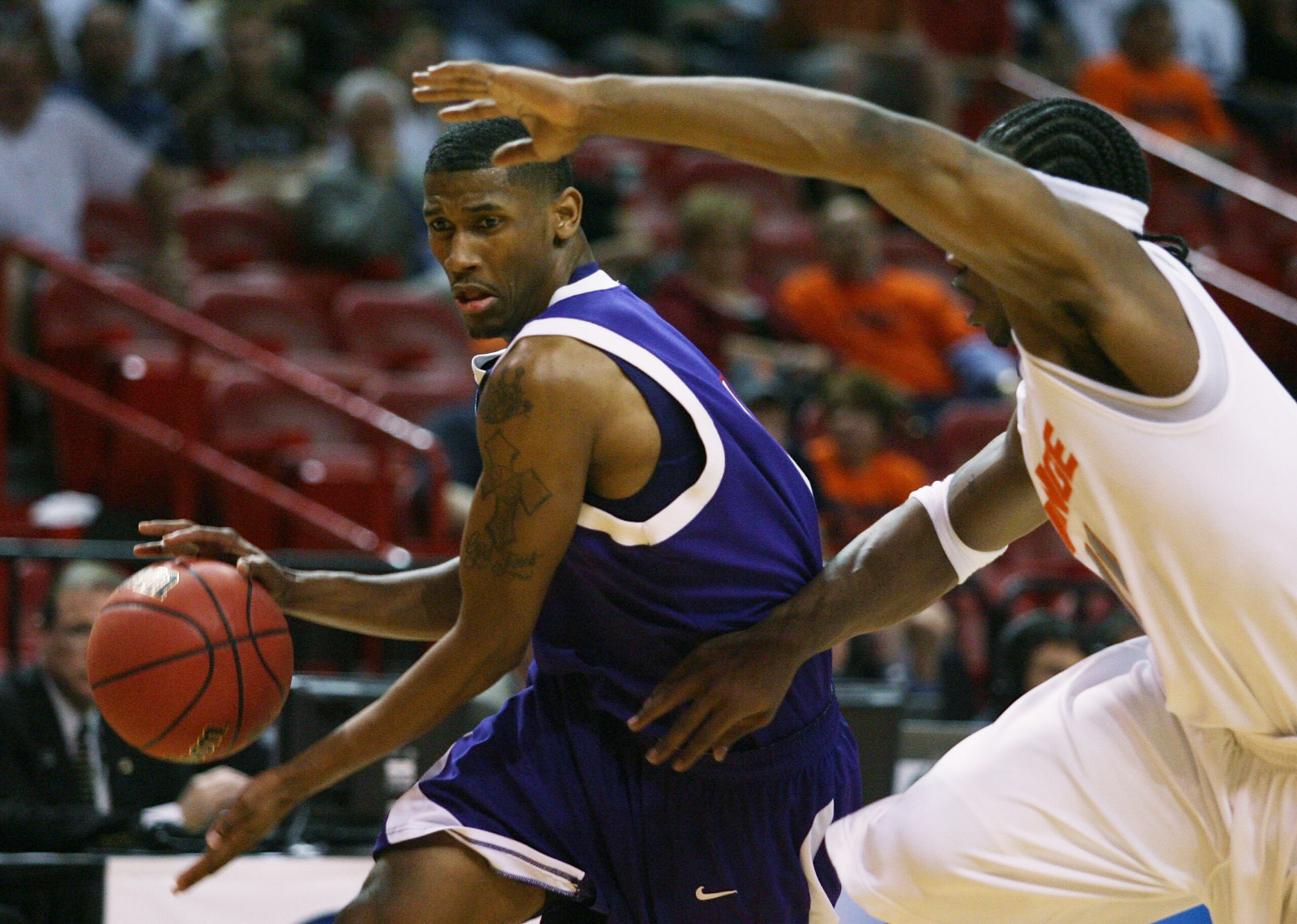 MIAMI - MARCH 20:  Guard Walt Harris #4 (L) of the  Stephen F. Austin Lumberjacks drives past  forward Paul Harris #11 of the Syracuse Orange during the first round of the NCAA Division I Men's Basketball Tournament at the American Airlines Arena on March