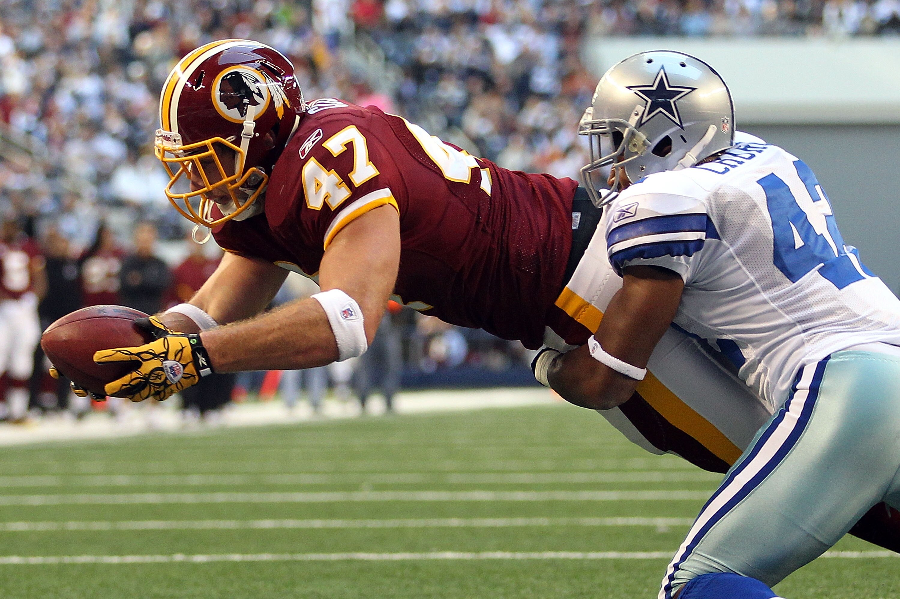 ARLINGTON, TX - DECEMBER 19:  Tight end Chris Cooley #47 of the Washington Redskins dives on a two point conversion against Barry Church #42 of the Dallas Cowboys at Cowboys Stadium on December 19, 2010 in Arlington, Texas.  (Photo by Ronald Martinez/Gett