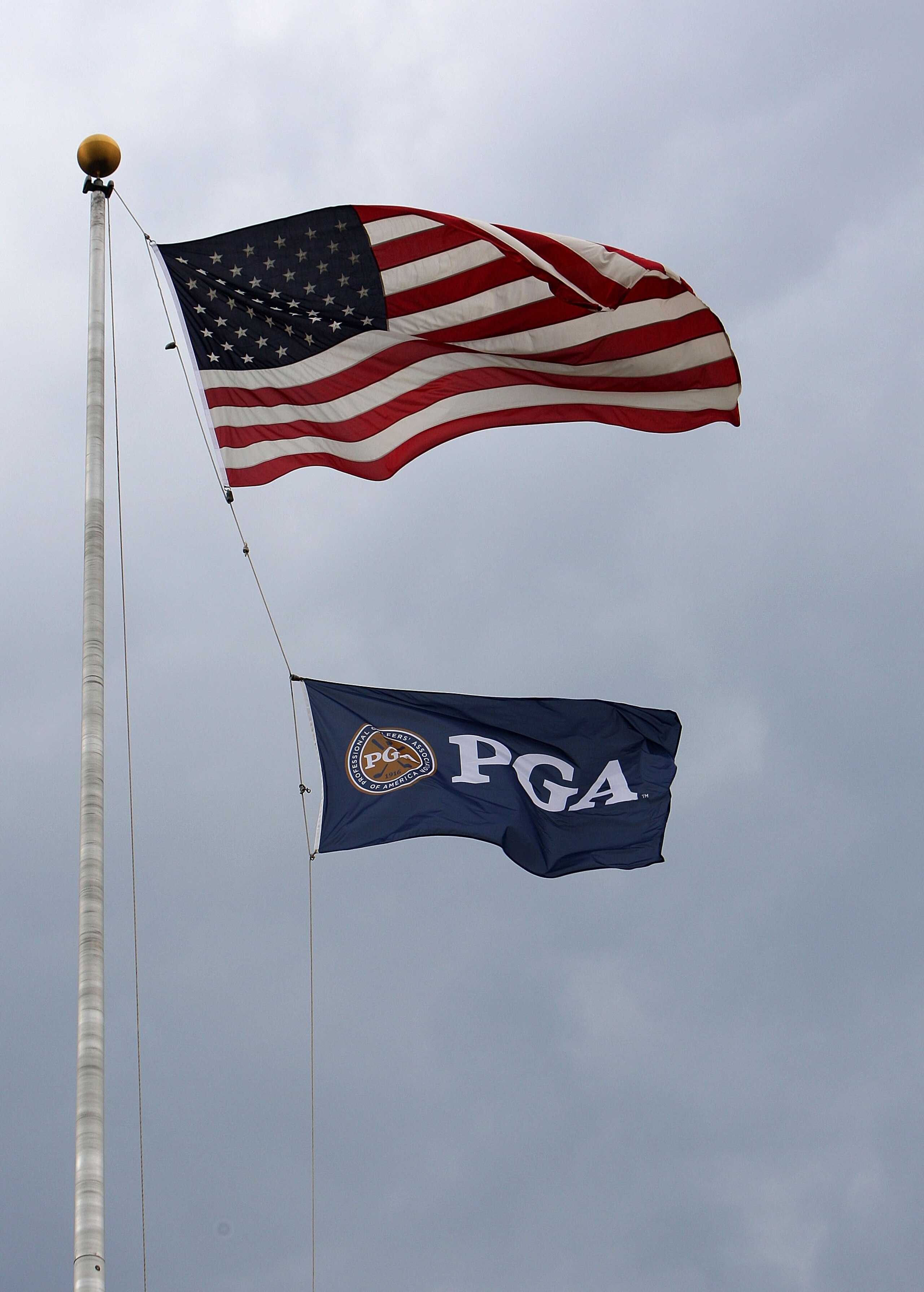 BLOOMFIELD HILLS, MI - AUGUST 09:  The American Flag and PGA of America Flag fly in the wind during a weather dellay during round three of the 90th PGA Championship at Oakland Hills Country Club on August 9, 2008 in Bloomfield Township, Michigan.  (Photo