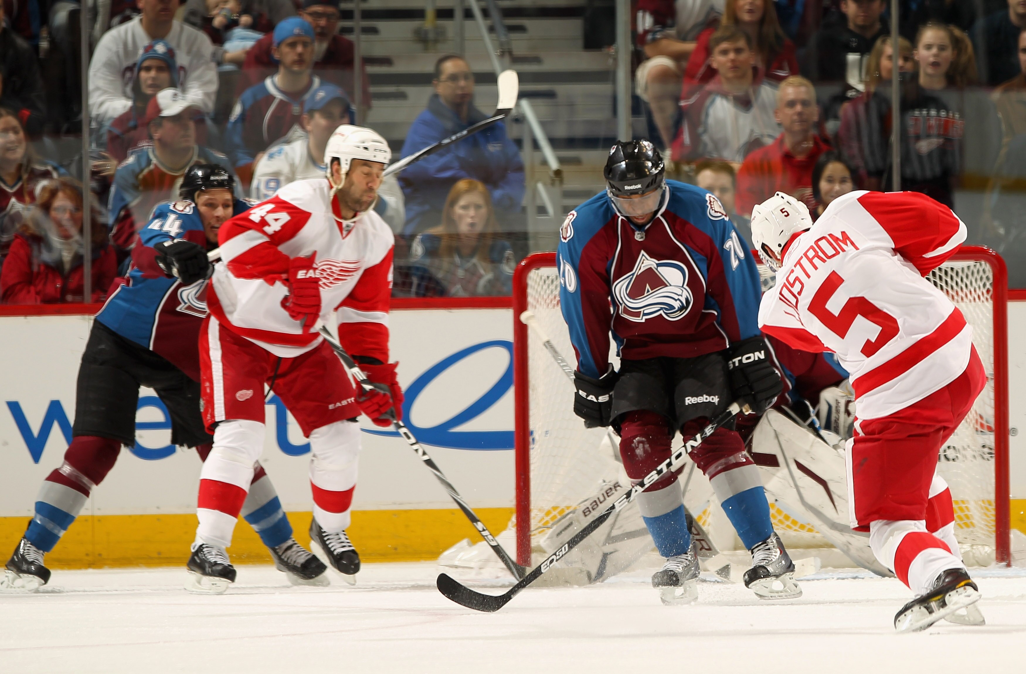 DENVER - DECEMBER 27:  Nicklas Lidstrom #5 of the Detroit Red Wings gets a shot past Greg Mauldin #20 of the Colorado Avalanche and goalie Peter Budaj for a third period goal at the Pepsi Center on December 27, 2010 in Denver, Colorado. Ryan Wilson #44 of