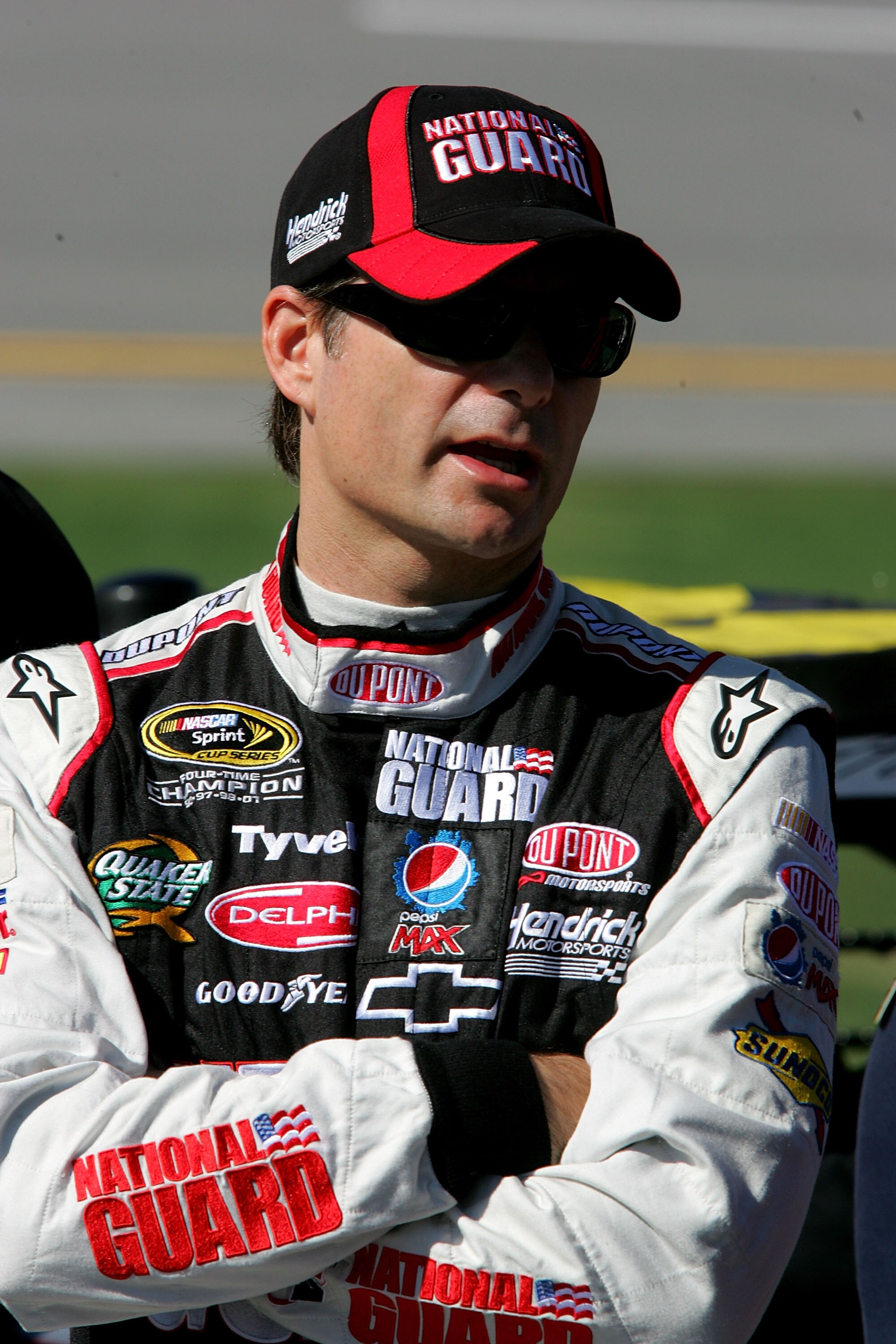 TALLADEGA, AL - OCTOBER 30:  Jeff Gordon, driver of the #24 DuPont/National Guard Chevrolet, stands next to his car on pit road during qualifying for the NASCAR Sprint Cup Series AMP Energy Juice 500 at Talladega Superspeedway on October 30, 2010 in Talla