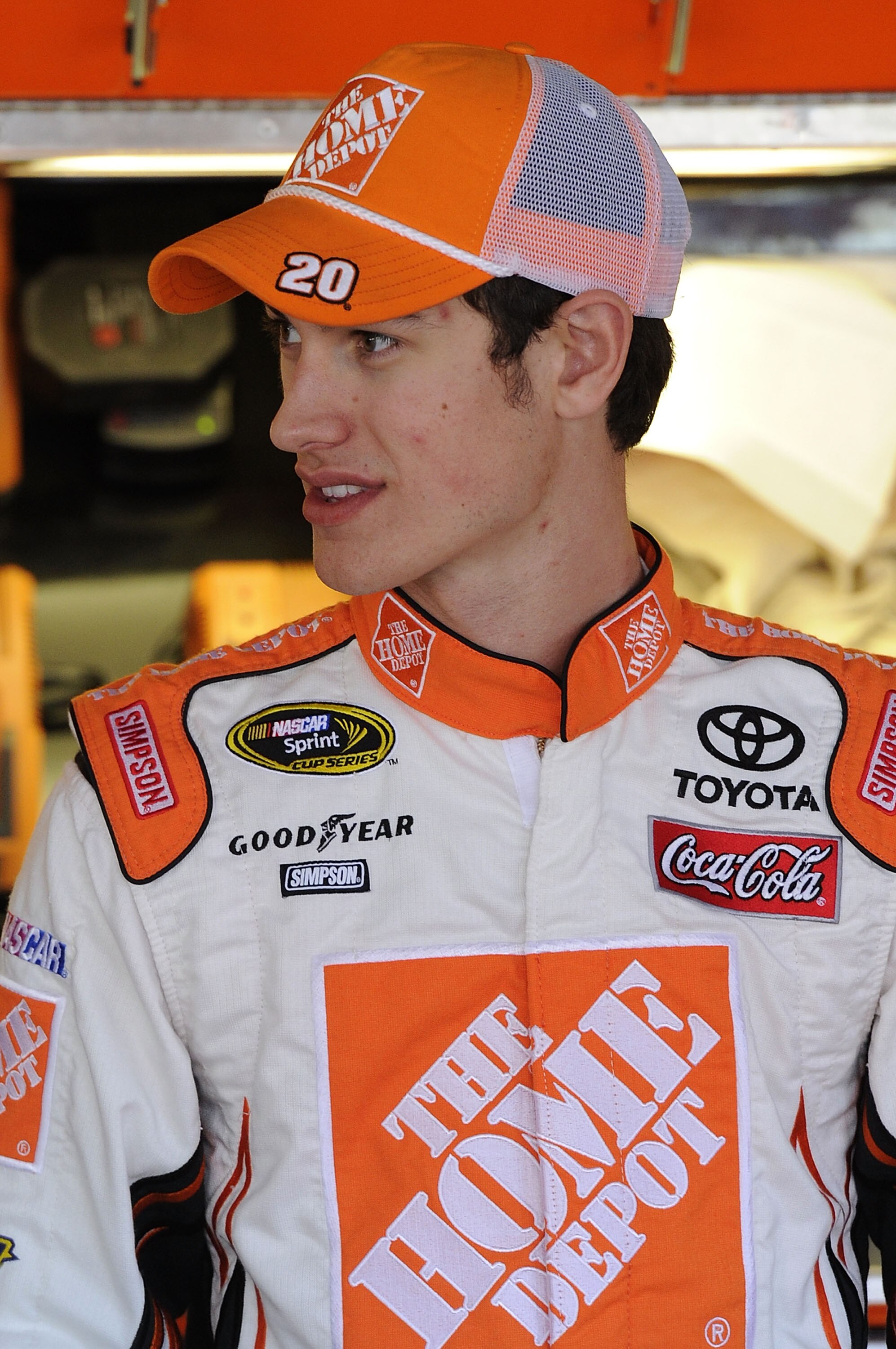 TALLADEGA, AL - OCTOBER 29:  Joey Logano, driver of the #20 Home Depot Toyota, stands in the garage during practice for the NASCAR Sprint Cup Series AMP Energy Juice 500 at Talladega Superspeedway on October 29, 2010 in Talladega, Alabama.  (Photo by John