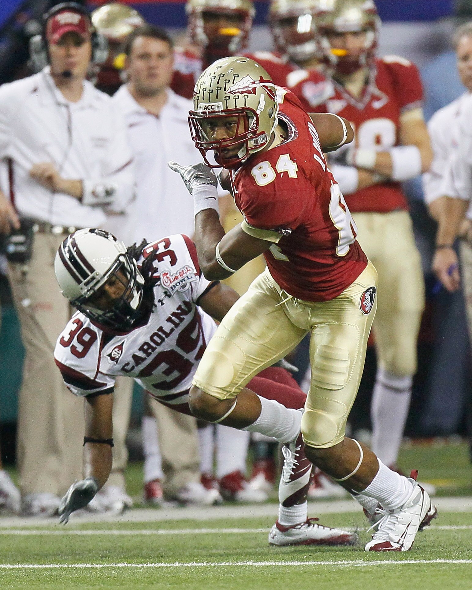ATLANTA, GA - DECEMBER 31:  Rodney Smith #84 of the Florida State Seminoles breaks a tackle by Marty Markett #39 of the South Carolina Gamecocks during the 2010 Chick-fil-A Bowl at Georgia Dome on December 31, 2010 in Atlanta, Georgia.  (Photo by Kevin C.