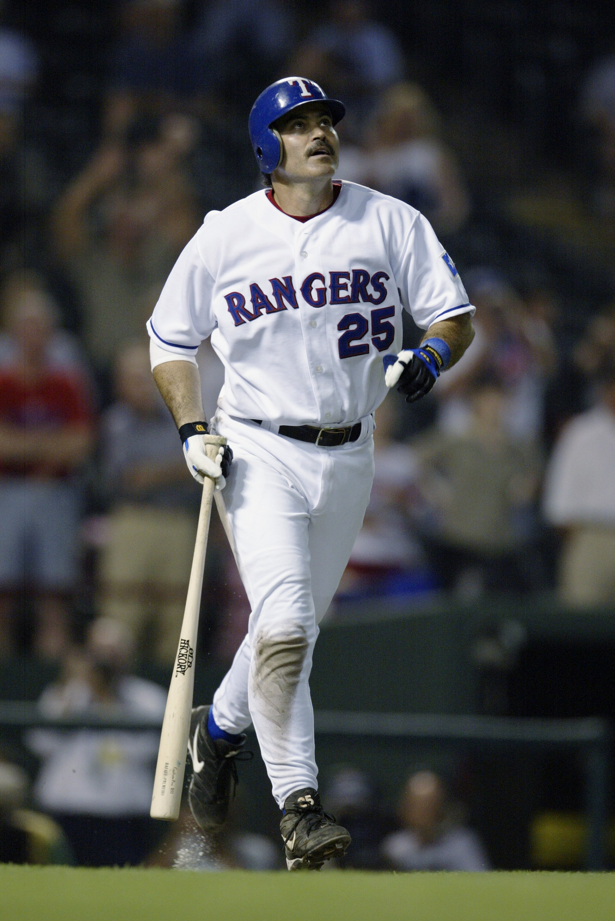 ARLINGTON, TX - MAY 9:  Rafael Palmeiro #25 of the Texas Rangers watches the flight of the ball while running down the first base line during the game against the Cleveland Indians at the Ballpark at Arlington on May 9, 2003 in Arlington, Texas.  The Indi
