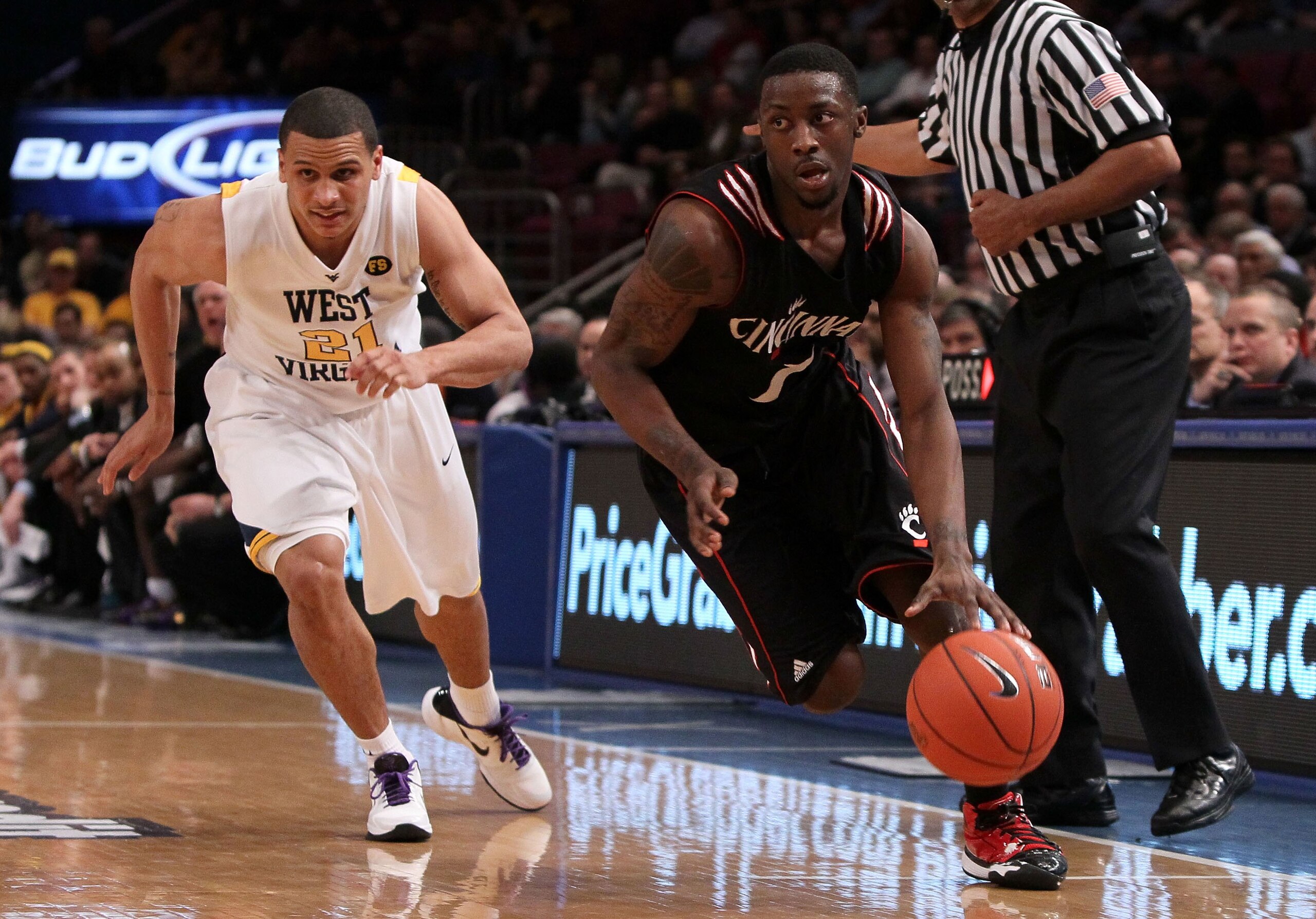 NEW YORK - MARCH 11: Cashmere Wright #1 of the Cincinnati Bearcats handles the ball against Joe Mazzulla #21 of the West Virginia Mountaineers during the quarterfinal of the 2010 NCAA Big East Tournament at Madison Square Garden on March 11, 2010 in New Y