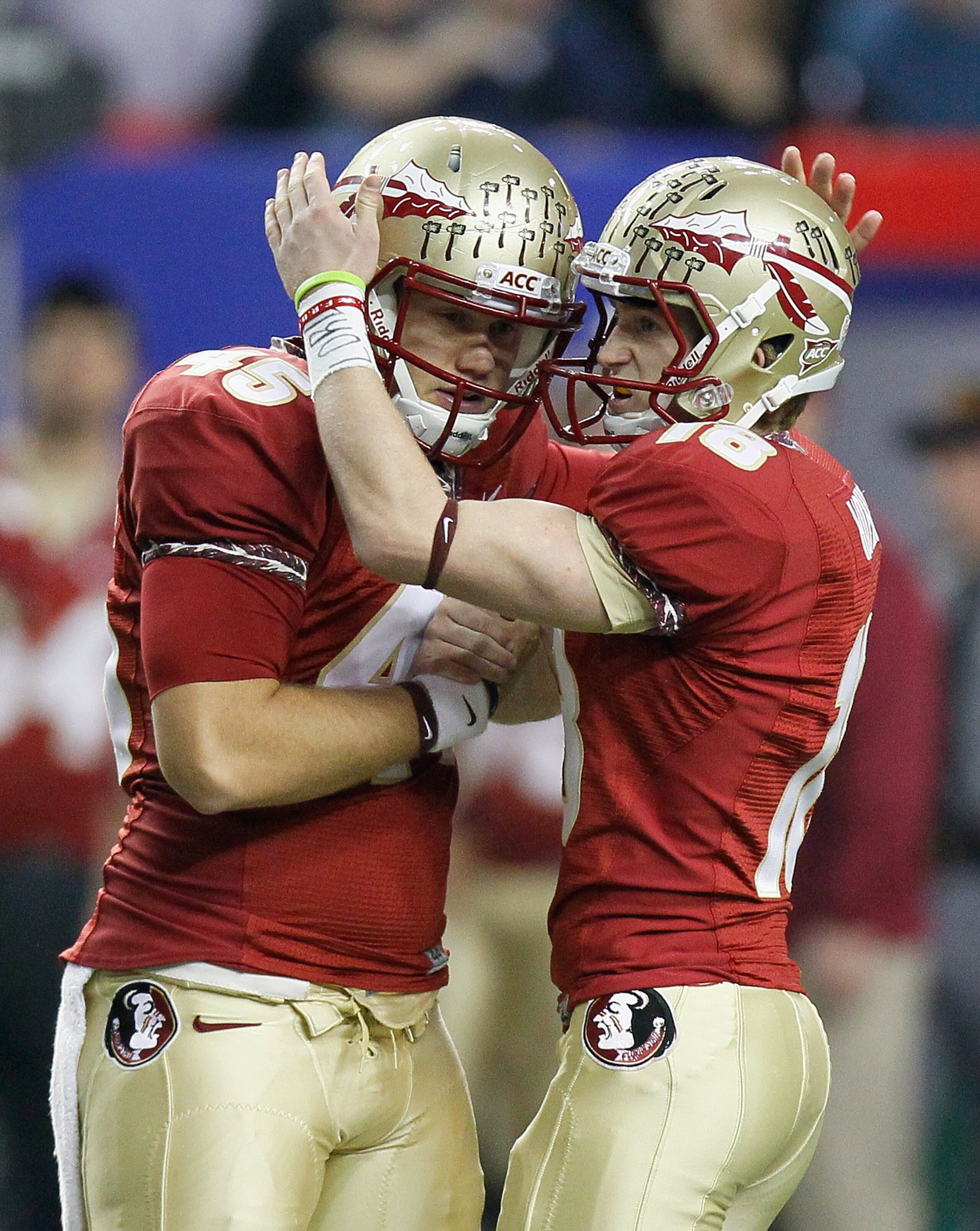 ATLANTA, GA - DECEMBER 31:  Dustin Hopkins #18 of the Florida State Seminoles reacts after kicking a field goal against the South Carolina Gamecocks with Shawn Powell #45 during the 2010 Chick-fil-A Bowl at Georgia Dome on December 31, 2010 in Atlanta, Ge