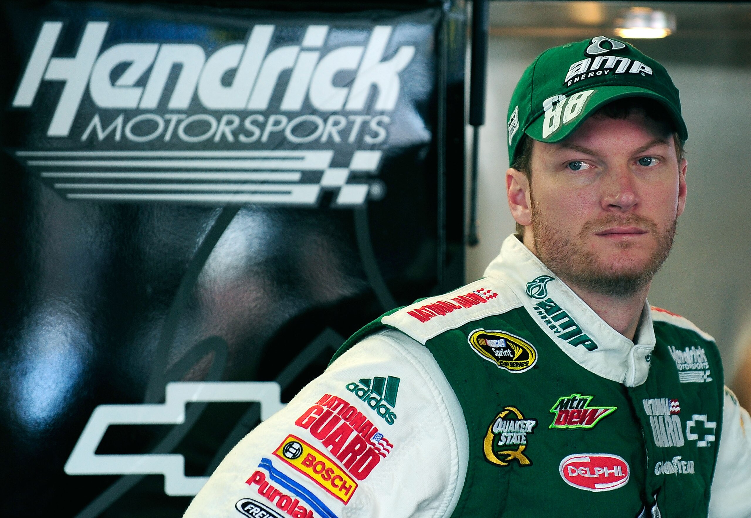 CONCORD, NC - OCTOBER 14:  Dale Earnhardt Jr., driver of the #88 AMP Energy/National Guard Chevrolet, stands in the garage during practice for the NASCAR Sprint Cup Series Bank of America 500 at Charlotte Motor Speedway on October 14, 2010 in Concord, Nor
