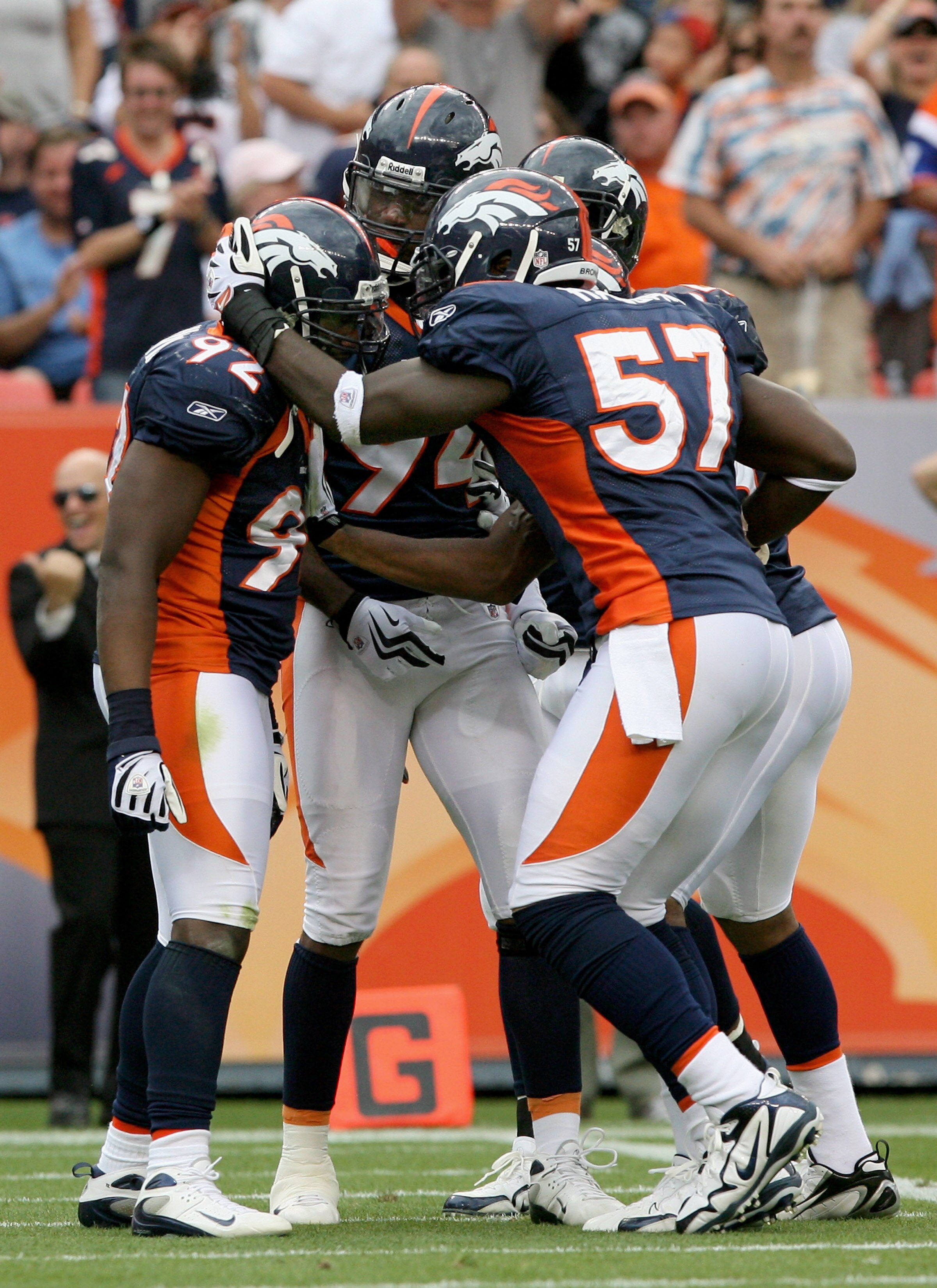 DENVER - SEPTEMBER 20:  Defensive end Elvis Dumervil #92 (L) of the Denver Broncos is congratulated by his teammates after he sacked quarterback Brady Quinn #10 of the Cleveland Browns in the fourth quarter during NFL action at Invesco Field at Mile High