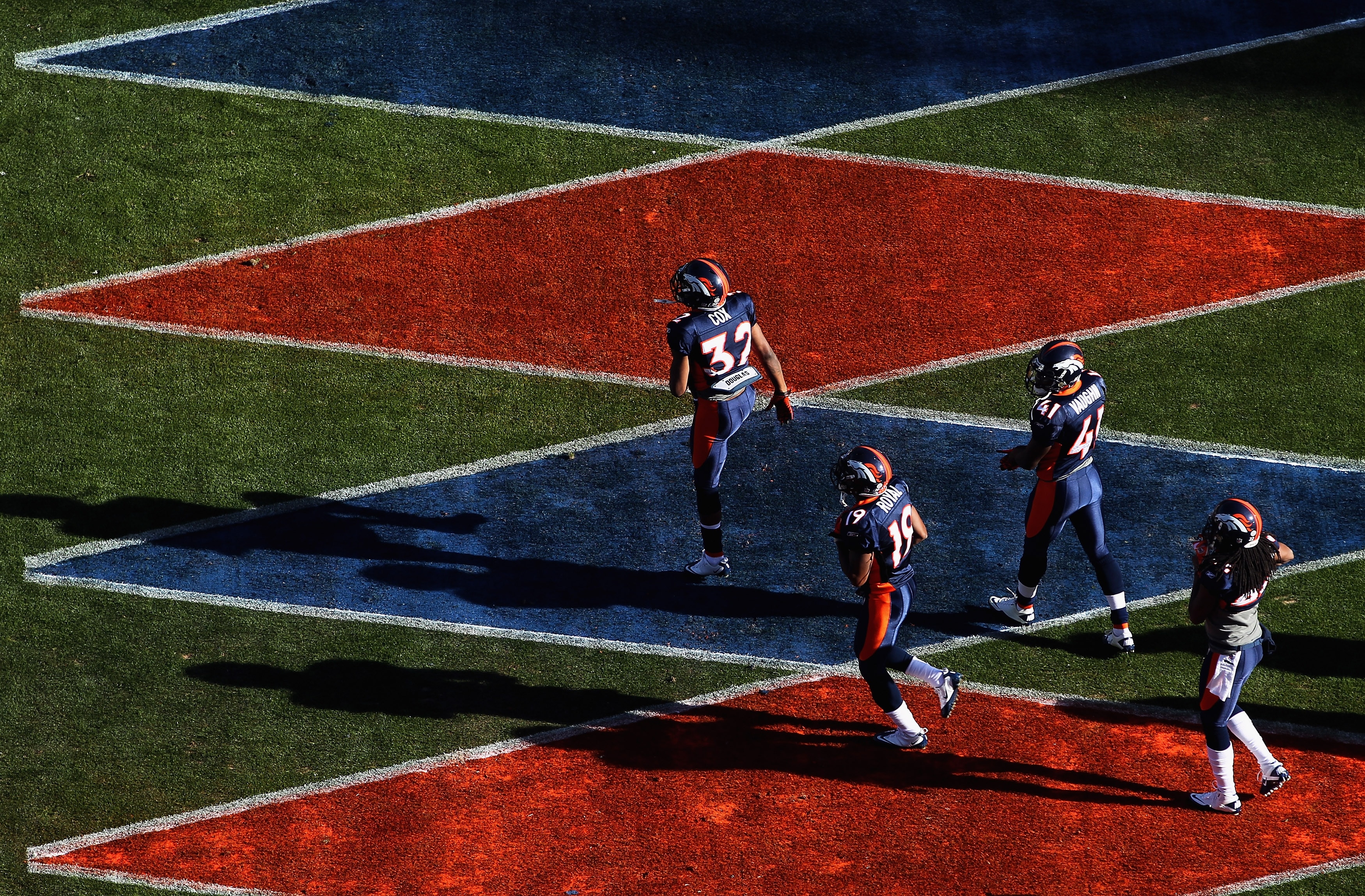 DENVER - DECEMBER 26:  Perrish Cox #32, Eddie Royal #19, Cassius Vaughn #41 and Syd'Quan Thompson #22 of the Denver Broncos take the field to warm up prior to facing the Houston Texas at INVESCO Field at Mile High on December 26, 2010 in Denver, Colorado.
