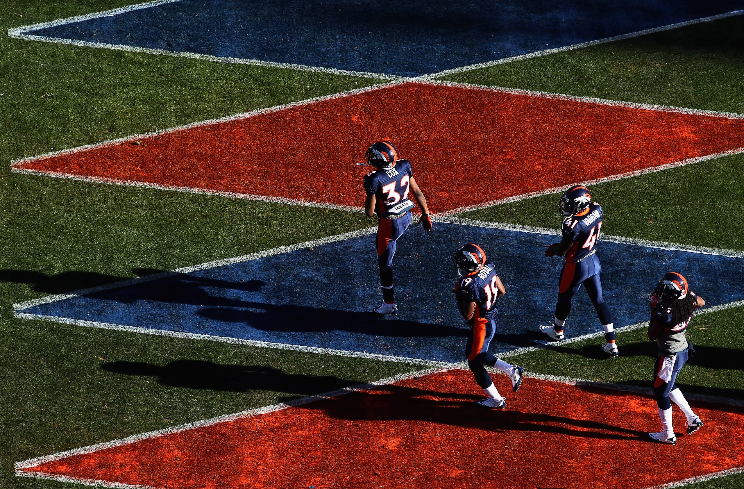 DENVER - DECEMBER 26:  Perrish Cox #32, Eddie Royal #19, Cassius Vaughn #41 and Syd'Quan Thompson #22 of the Denver Broncos take the field to warm up prior to facing the Houston Texas at INVESCO Field at Mile High on December 26, 2010 in Denver, Colorado.