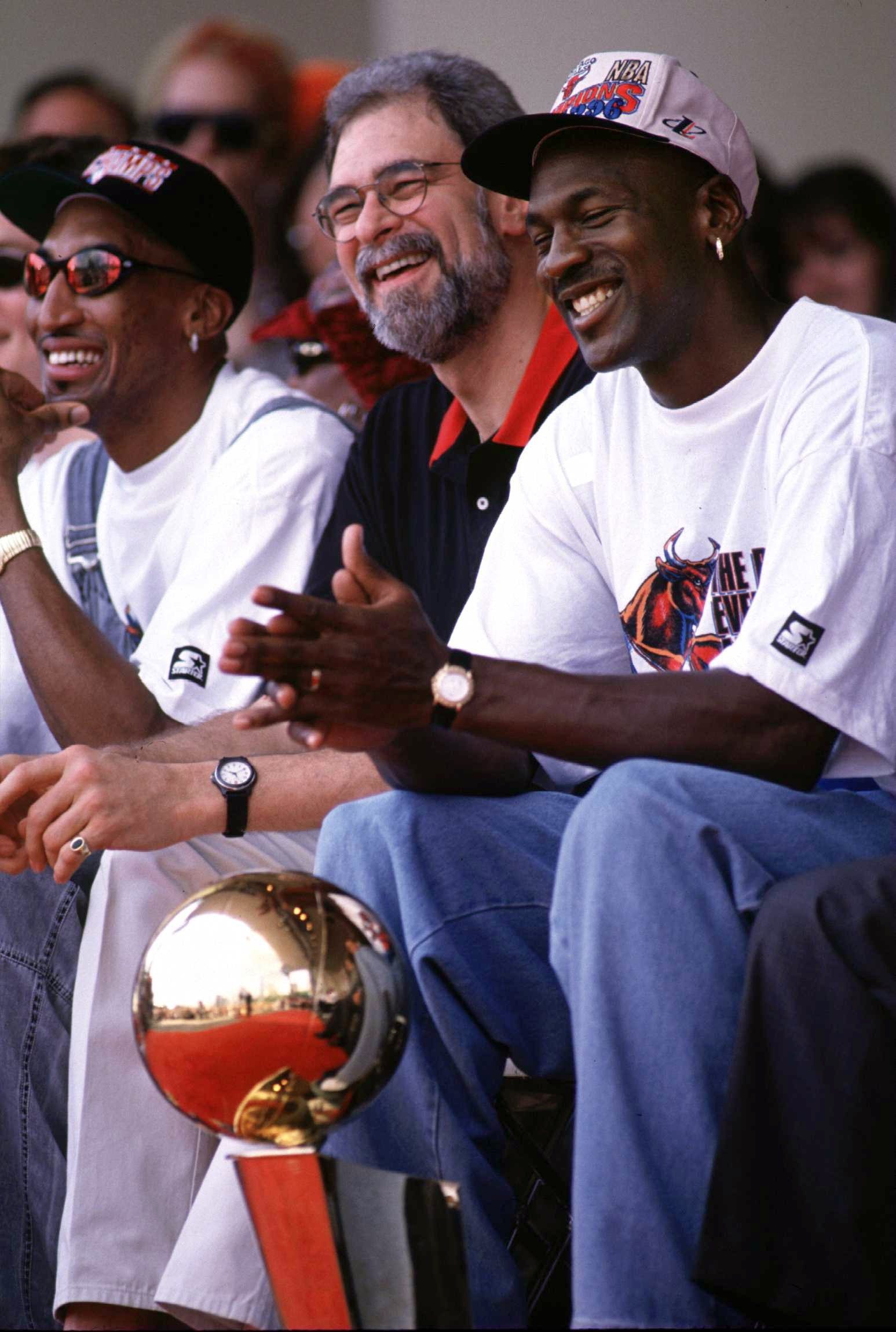 18 Jun 1996:  Scottie Pippen, coach Phil Jackson and Michael Jordan (left to right) of the Chicago Bulls share a joke during the Bulls'' 1996 NBA Championship Victory parade in Chicago, Illinois, after the Bulls won their 4th NBA championship in 6 years.