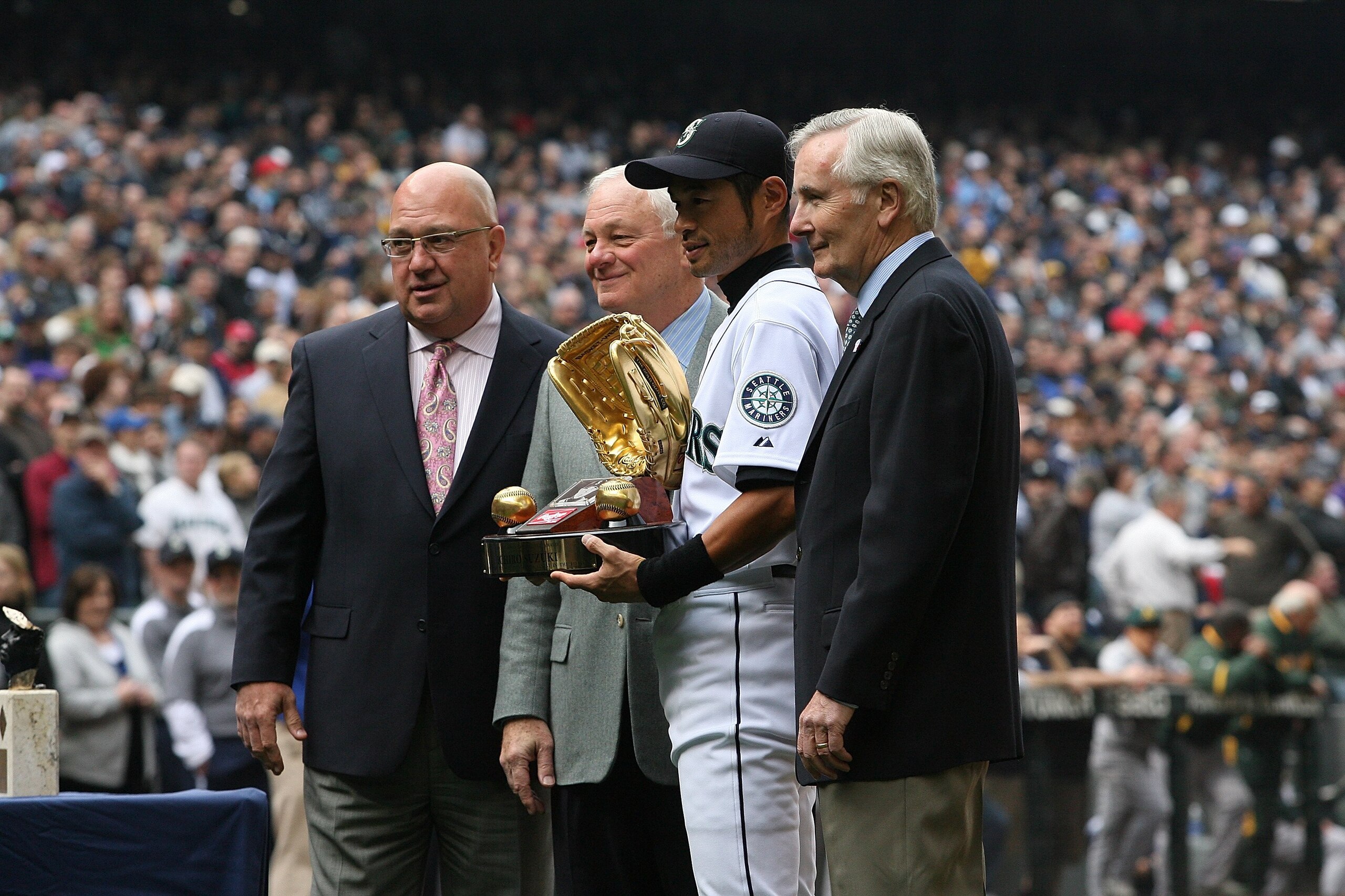 SEATTLE - APRIL 12:  L to R: General manager Jack Zduriencik, team president Chuck Armstrong, Ichiro Suzuki #51, and CEO Howard Lincoln of the Seattle Mariners pose for a photo as Suzuki is presented with the Gold Glove Award prior to the Mariners' home o