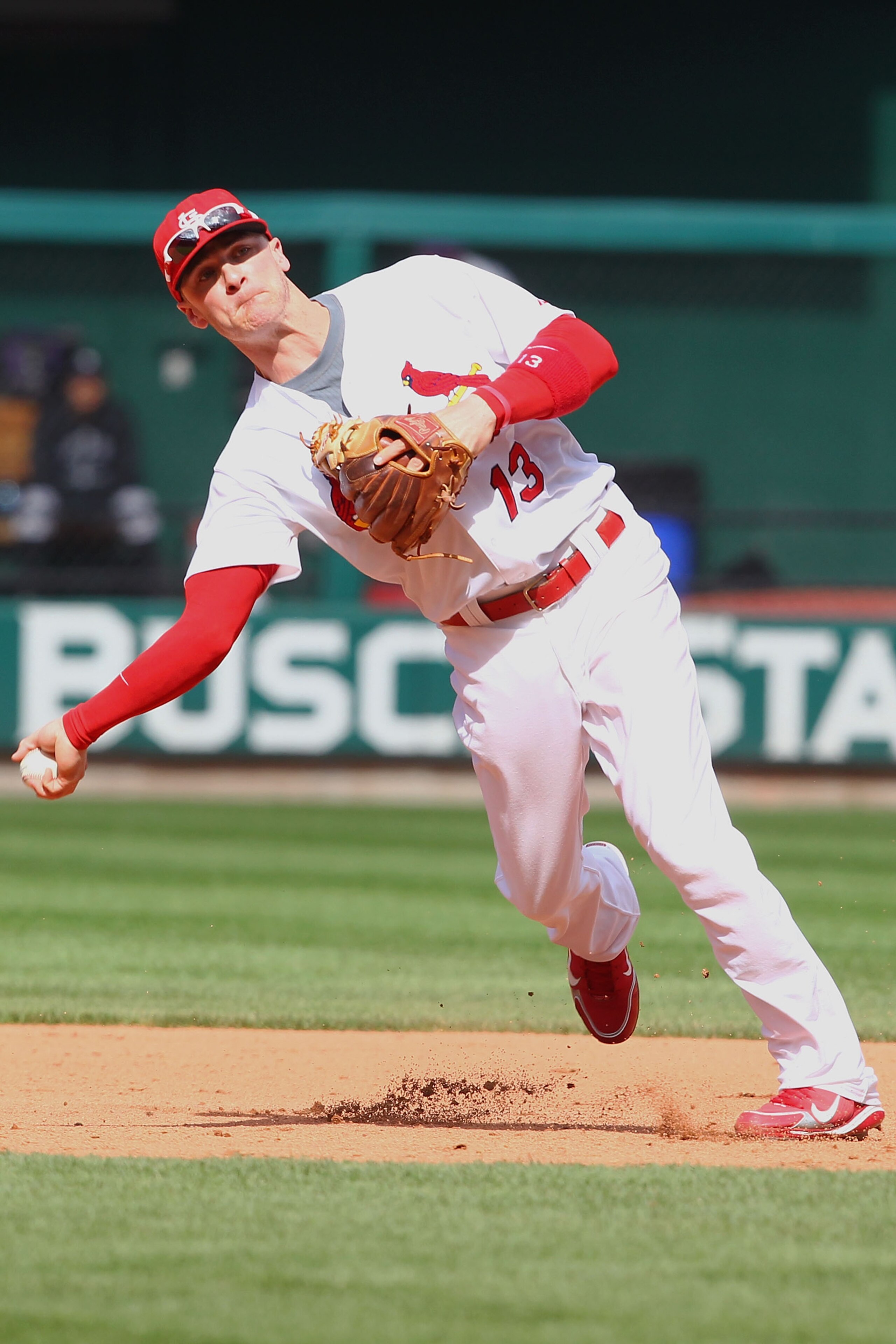 ST. LOUIS - OCTOBER 2: Brendan Ryan #13 of the St. Louis Cardinals throws to first base against the Colorado Rockies at Busch Stadium on October 2, 2010 in St. Louis, Missouri.  The Cardinals beat the Rockies 1-0 in 11 innings.  (Photo by Dilip Vishwanat/