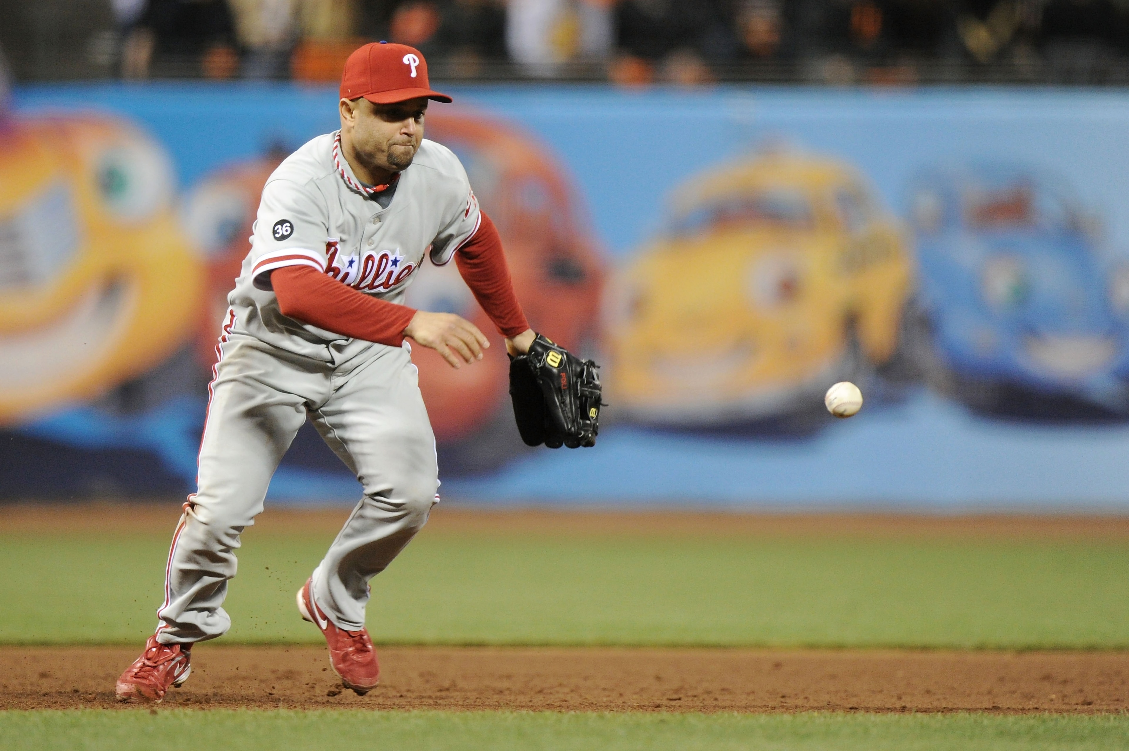 SAN FRANCISCO - OCTOBER 20: Placido Polanco #27 of the Philadelphia Phillies misplays a ground ball hit by Edgar Renteria #16 of the San Francisco Giants in the fifth inning of Game Four of the NLCS during the 2010 MLB Playoffs at AT&T Park on October 20 SAN FRANCISCO - OCTOBER 20: Placido Polanco #27 of the Philadelphia Phillies misplays a ground ball hit by Edgar Renteria #16 of the San Francisco Giants in the fifth inning of Game Four of the NLCS during the 2010 MLB Playoffs at AT&T Park on October 20