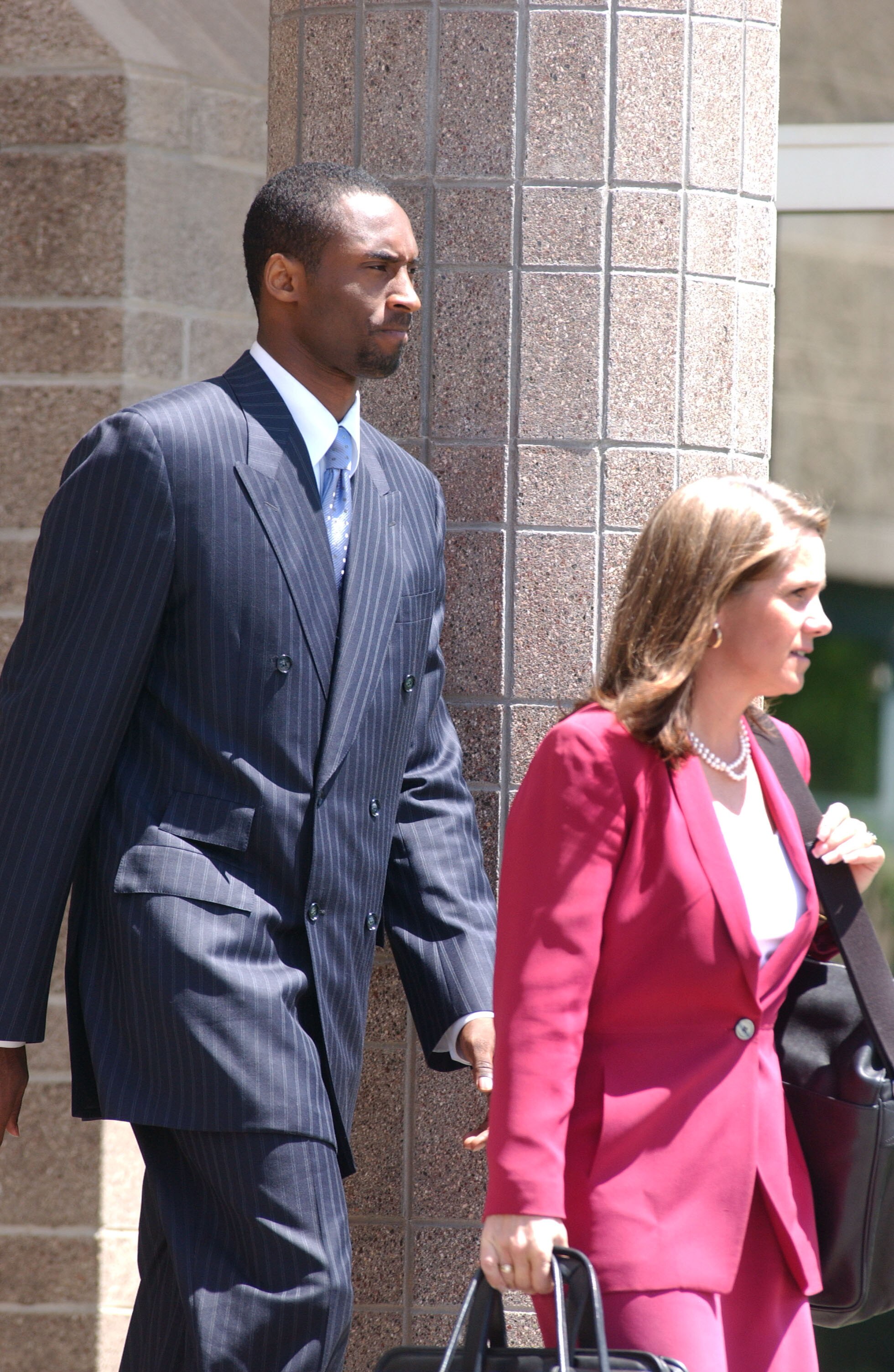 EAGLE, CO- JULY 19: Los Angeles Lakers star Kobe Bryant and his attorney Pamela Mackey leave for a lunch break at the Eagle County Courthouse July 19, 2004 in Eagle, Colorado. Lawyers for Bryant want the judge to allow cell phone text messages between the