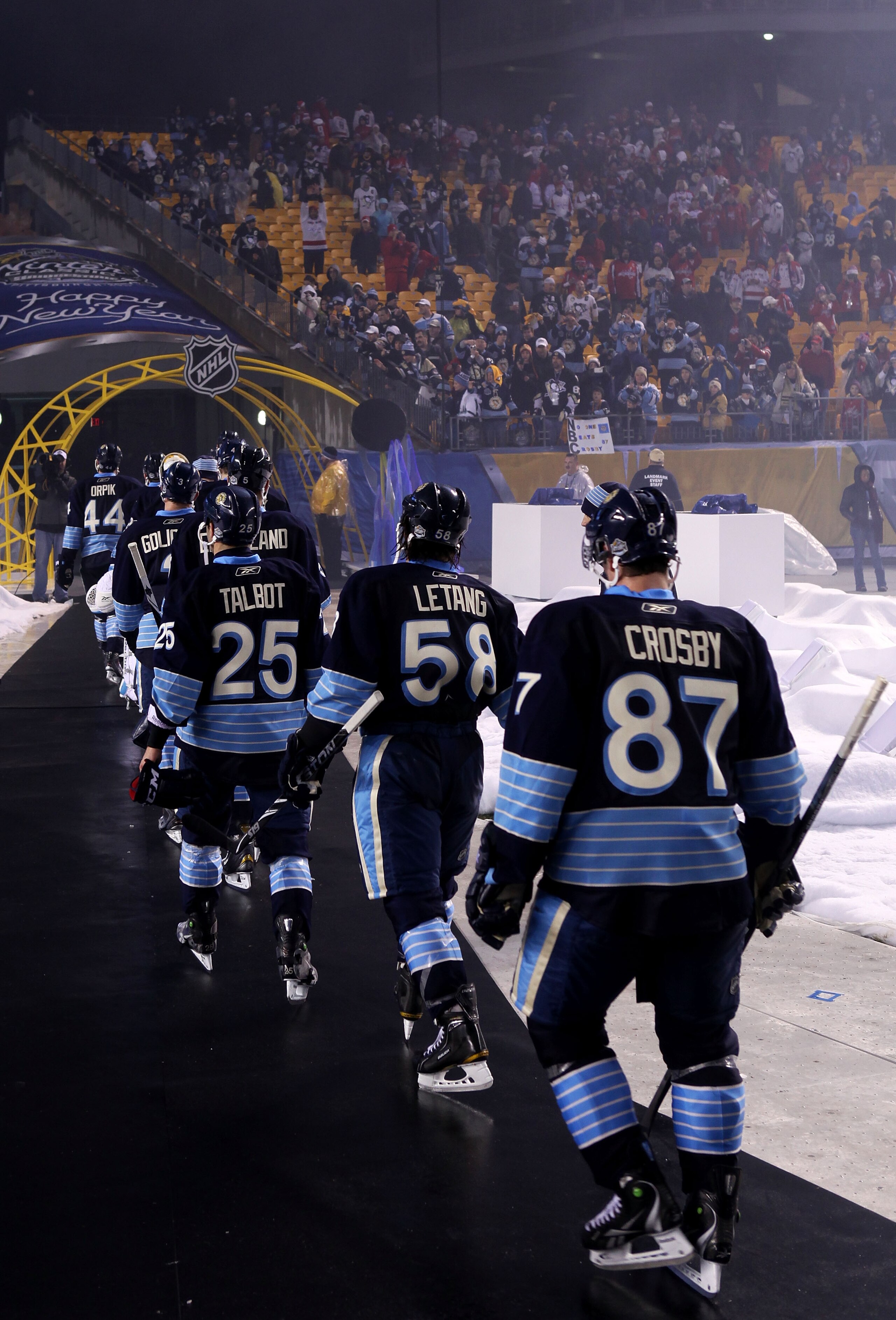 PITTSBURGH, PA - JANUARY 01:  Sidney Crosby #87 of the Pittsburgh Penguins walks off the ice with teammates after being defeated 3-1 by the Washington Capitals during the 2011 NHL Bridgestone Winter Classic at Heinz Field on January 1, 2011 in Pittsburgh,
