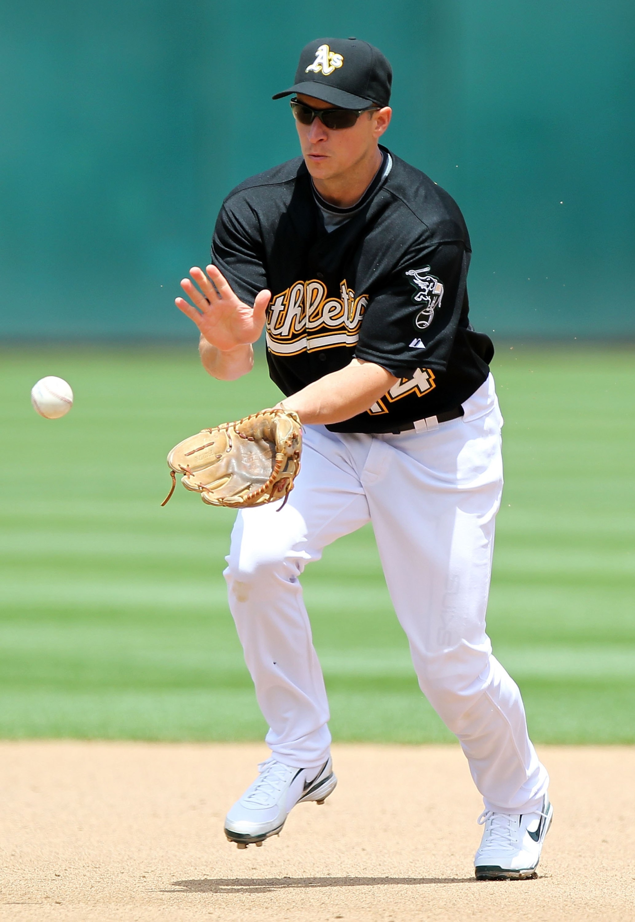 OAKLAND, CA - MAY 22:  Mark Ellis #14 of the Oakland fields against the San Francisco Giants during an MLB game at the Oakland-Alameda County Coliseum on May 22, 2010 in Oakland, California.  (Photo by Jed Jacobsohn/Getty Images)