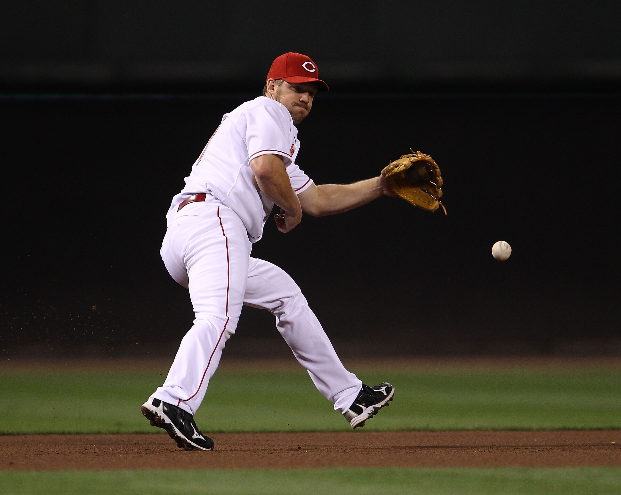 CINCINNATI - OCTOBER 10: Scott Rolen #27 of the Cincinnati Reds fields the ball against the Philadelphia Phillies during game 3 of the NLDS at Great American Ball Park on October 10, 2010 in Cincinnati, Ohio. The Phillies defeated the Reds 2-0. (Photo by