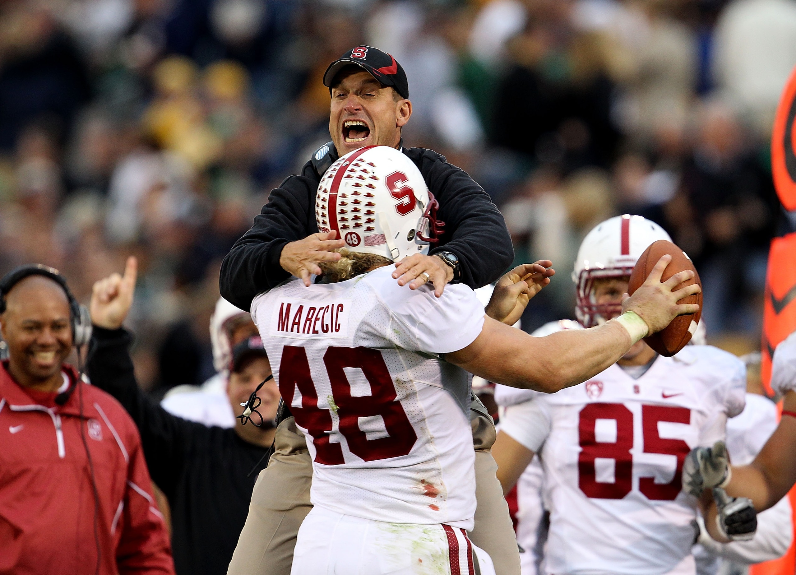 SOUTH BEND, IN - SEPTEMBER 25: Head coach Jim Harbaugh of the Stanford Cardinal jumps to greet Owen Marecic #48 after Marecic intercepted a pass for a touchdown against the Notre Dame Fighting Irish at Notre Dame Stadium on September 25, 2010 in South Ben