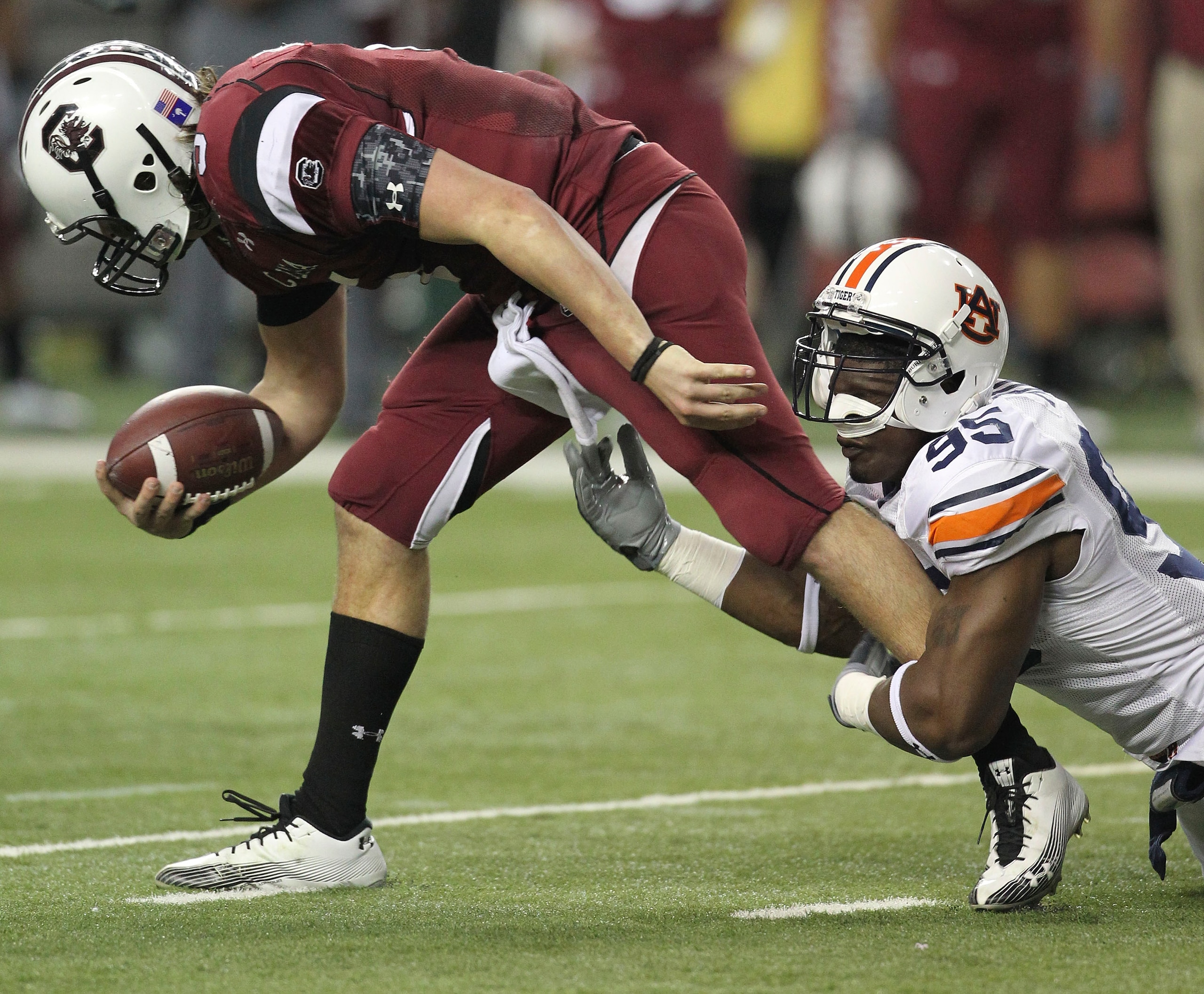 ATLANTA - DECEMBER 4:  Defensive end Dee Ford #95 of the Auburn Tigers tackles quarterback Stephen Garcia #5 of the South Carolina Gamecocks during the 2010 SEC Championship against the at Georgia Dome on December 4, 2010 in Atlanta, Georgia. (Photo by Mi