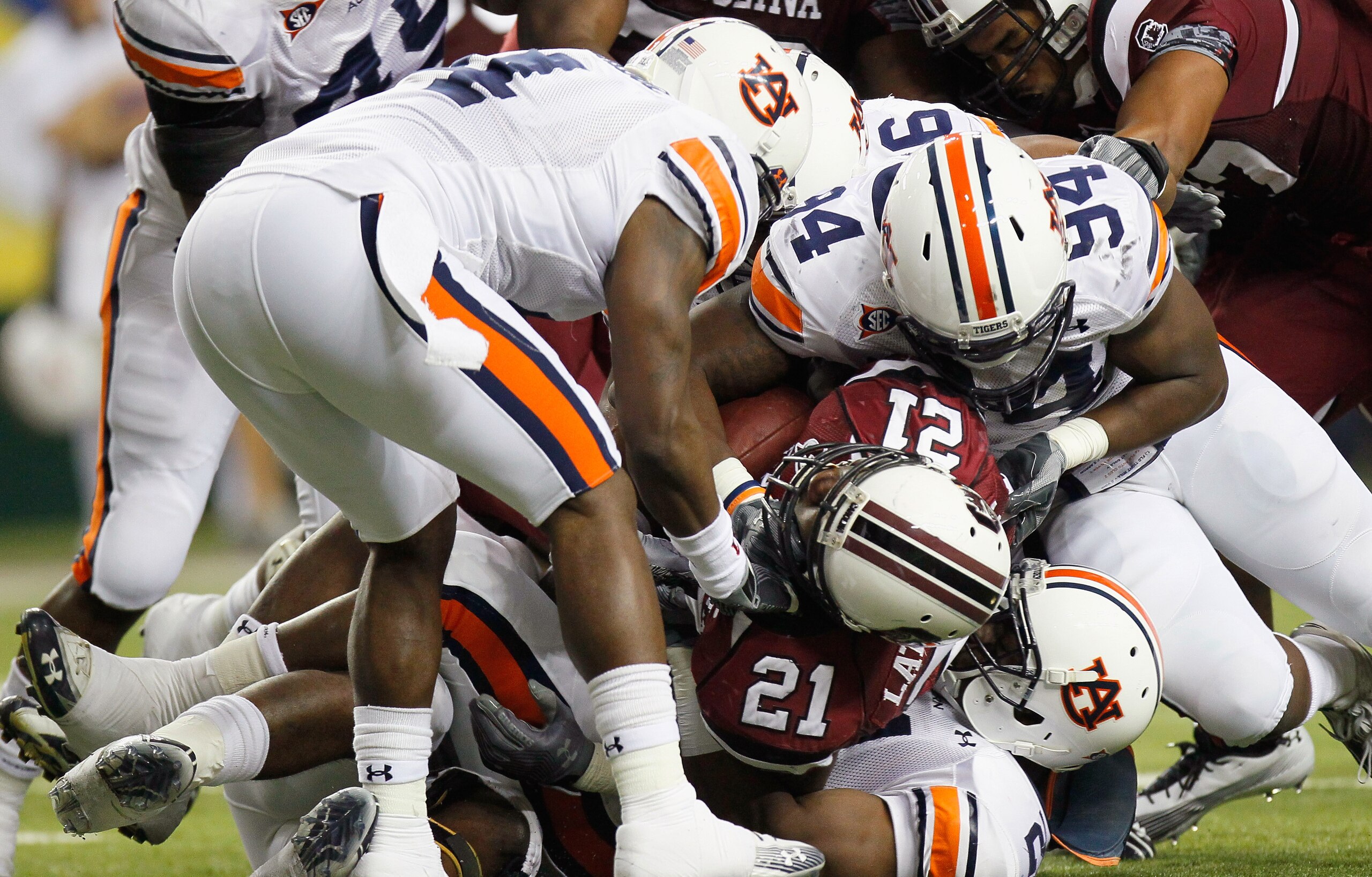 ATLANTA, GA - DECEMBER 04:  Marcus Lattimore #21 of the South Carolina Gamecocks is tackled by Zac Etheridge #4, Nosa Eguae #94 and Eltoro Freeman #21 of the Auburn Tigers during the 2010 SEC Championship at Georgia Dome on December 4, 2010 in Atlanta, Ge