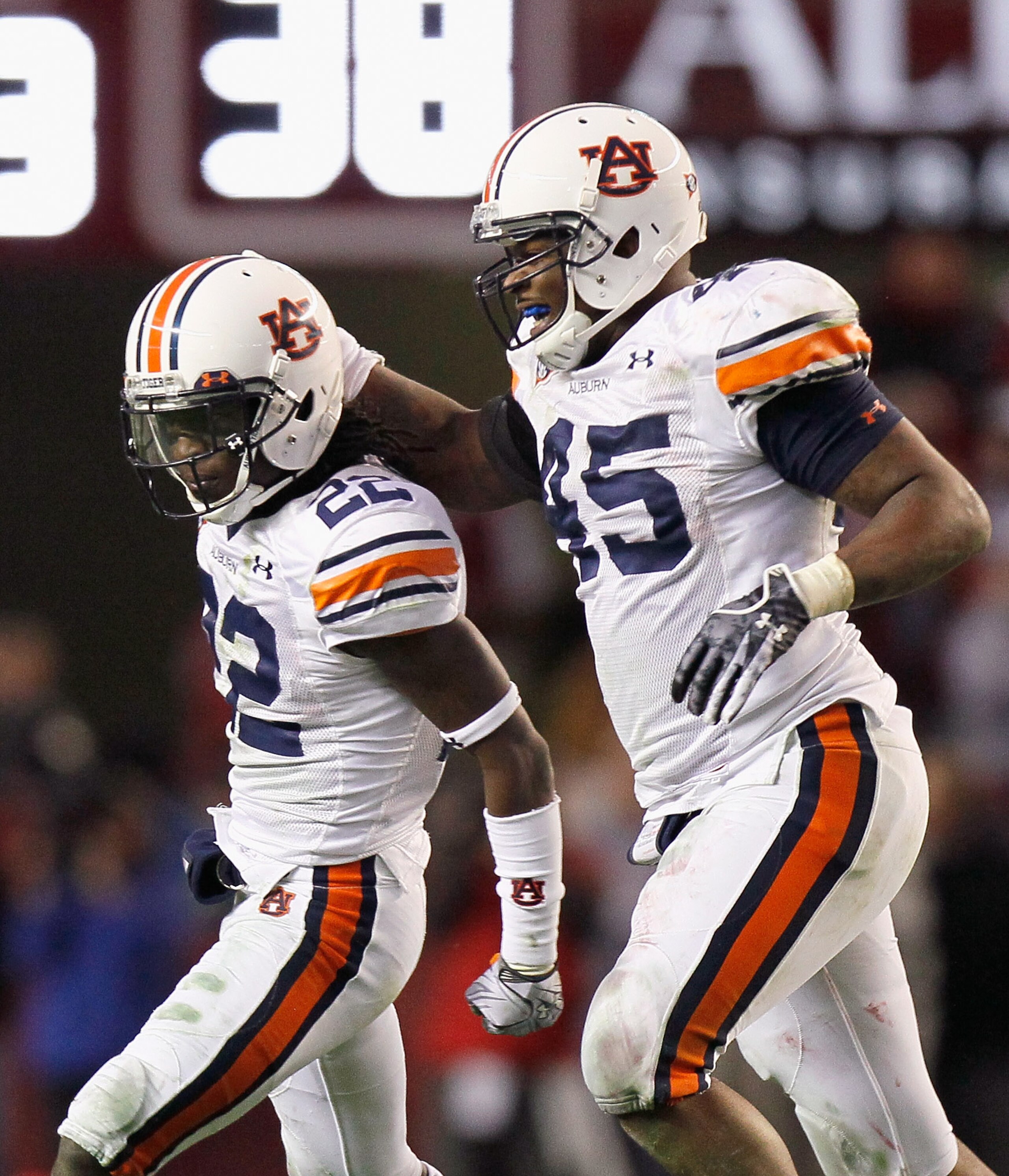 TUSCALOOSA, AL - NOVEMBER 26:  T'Sharvan Bell #22 and Antoine Carter #45 of the Auburn Tigers celebrate after Bell sacked quarterback Greg McElroy #12 of the Alabama Crimson Tide at Bryant-Denny Stadium on November 26, 2010 in Tuscaloosa, Alabama.  McElro