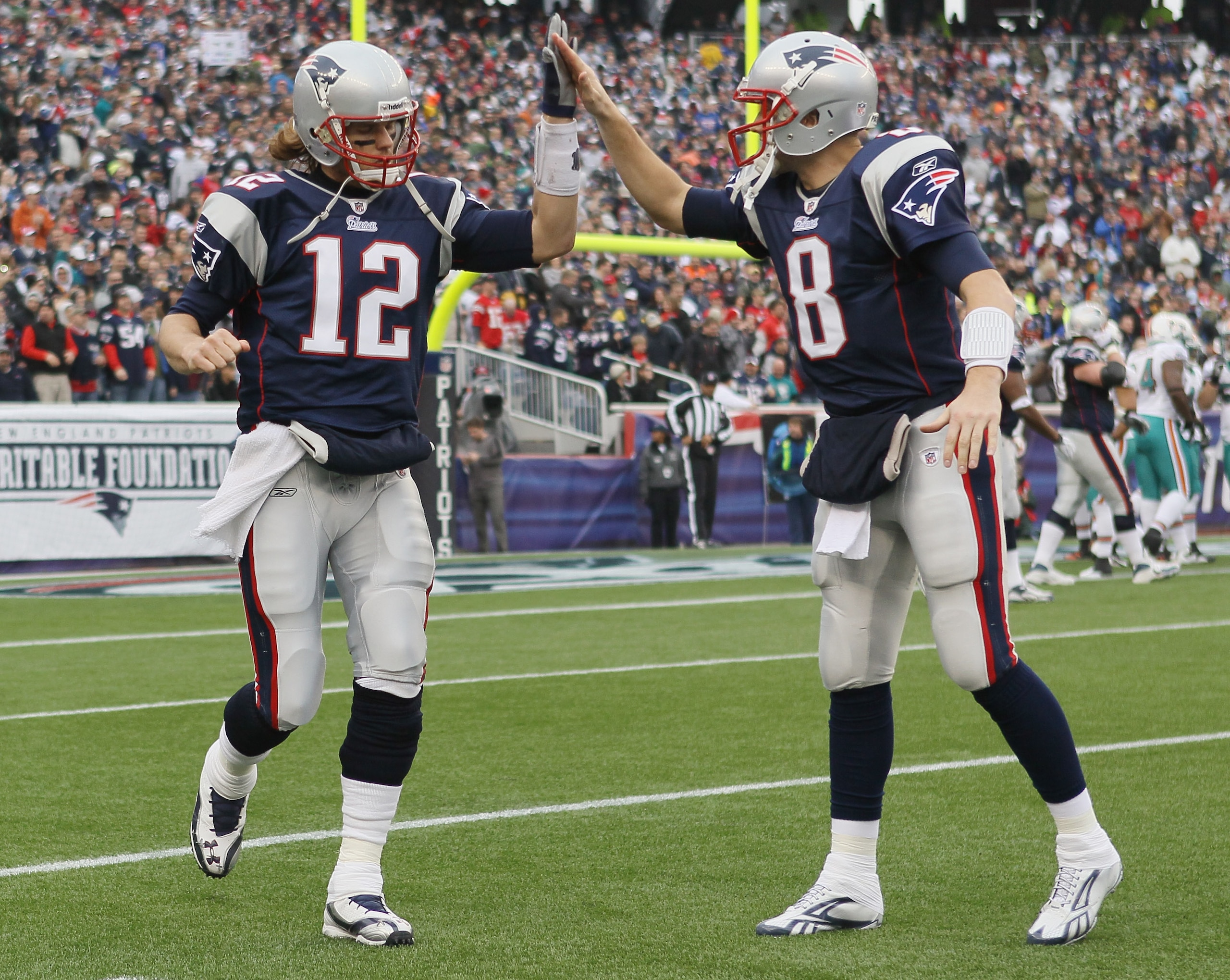FOXBORO, MA - JANUARY 02:  Tom Brady #12of the New England Patriots celebrates the touchdown with teammate Brian Hoyer #8 in the first half against the Miami Dolphins on January 2, 2011 at Gillette Stadium in Foxboro, Massachusetts.  (Photo by Elsa/Getty