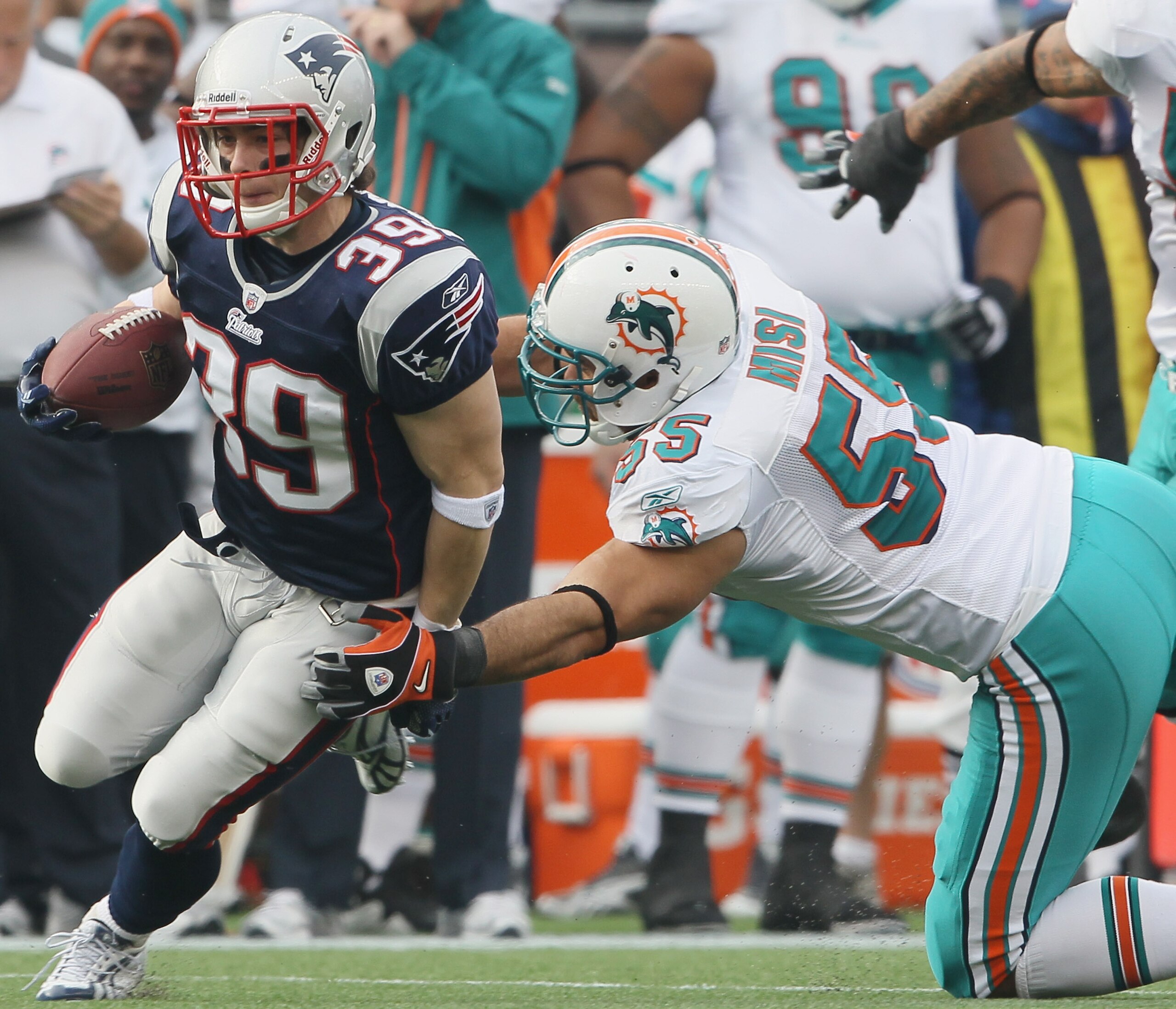 FOXBORO, MA - JANUARY 02:  Danny Woodhead #39 of the New England Patriots tries to avoid Koa Misi #55 of the Miami Dolphins on January 2, 2011 at Gillette Stadium in Foxboro, Massachusetts.  (Photo by Elsa/Getty Images)