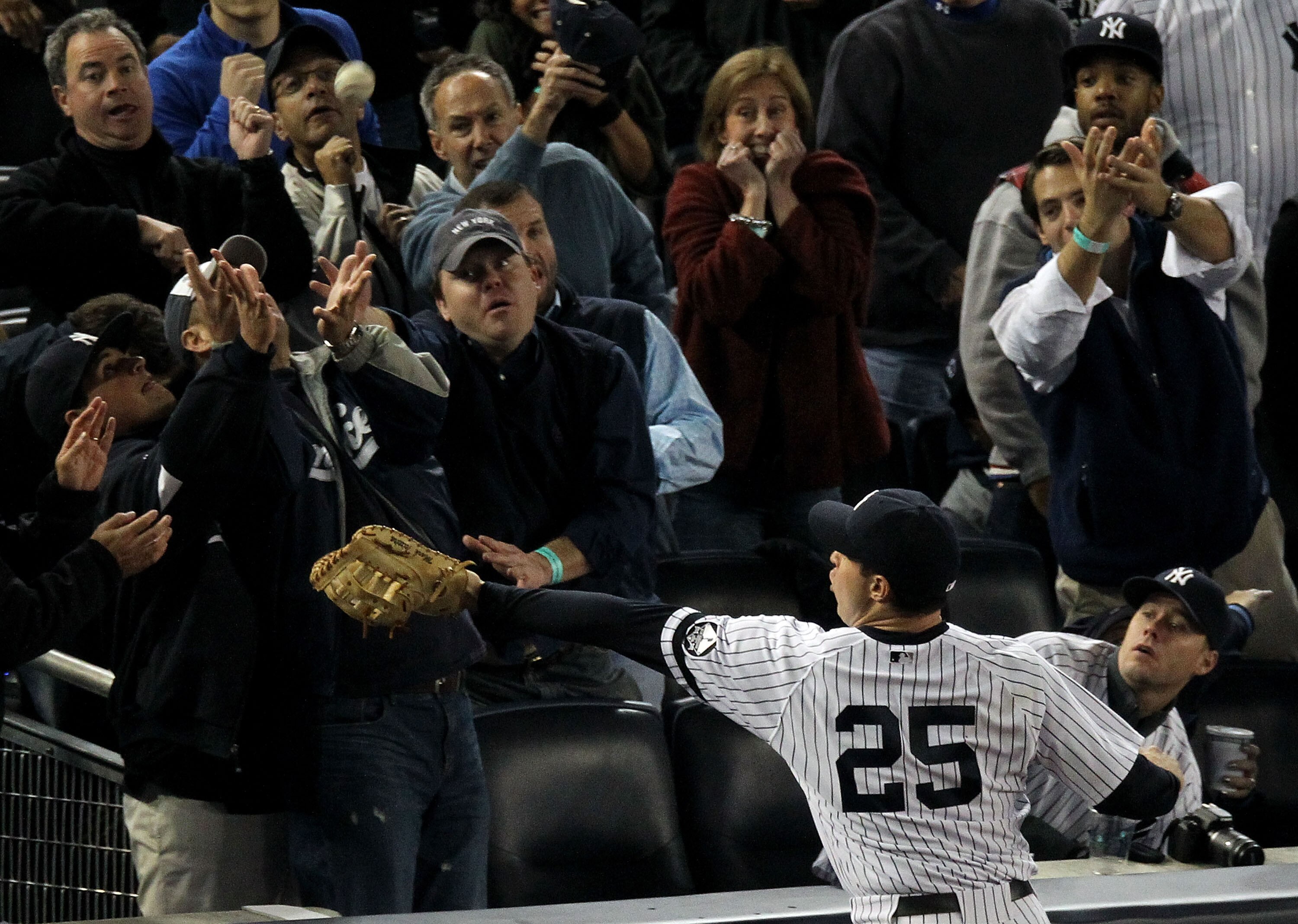 NEW YORK - OCTOBER 19:  Mark Teixeira #25 of the New York Yankees fails to make a play on a foul ball hit into the stands in the top of the fourth inning against the Texas Rangers in Game Four of the ALCS during the 2010 MLB Playoffs at Yankee Stadium on